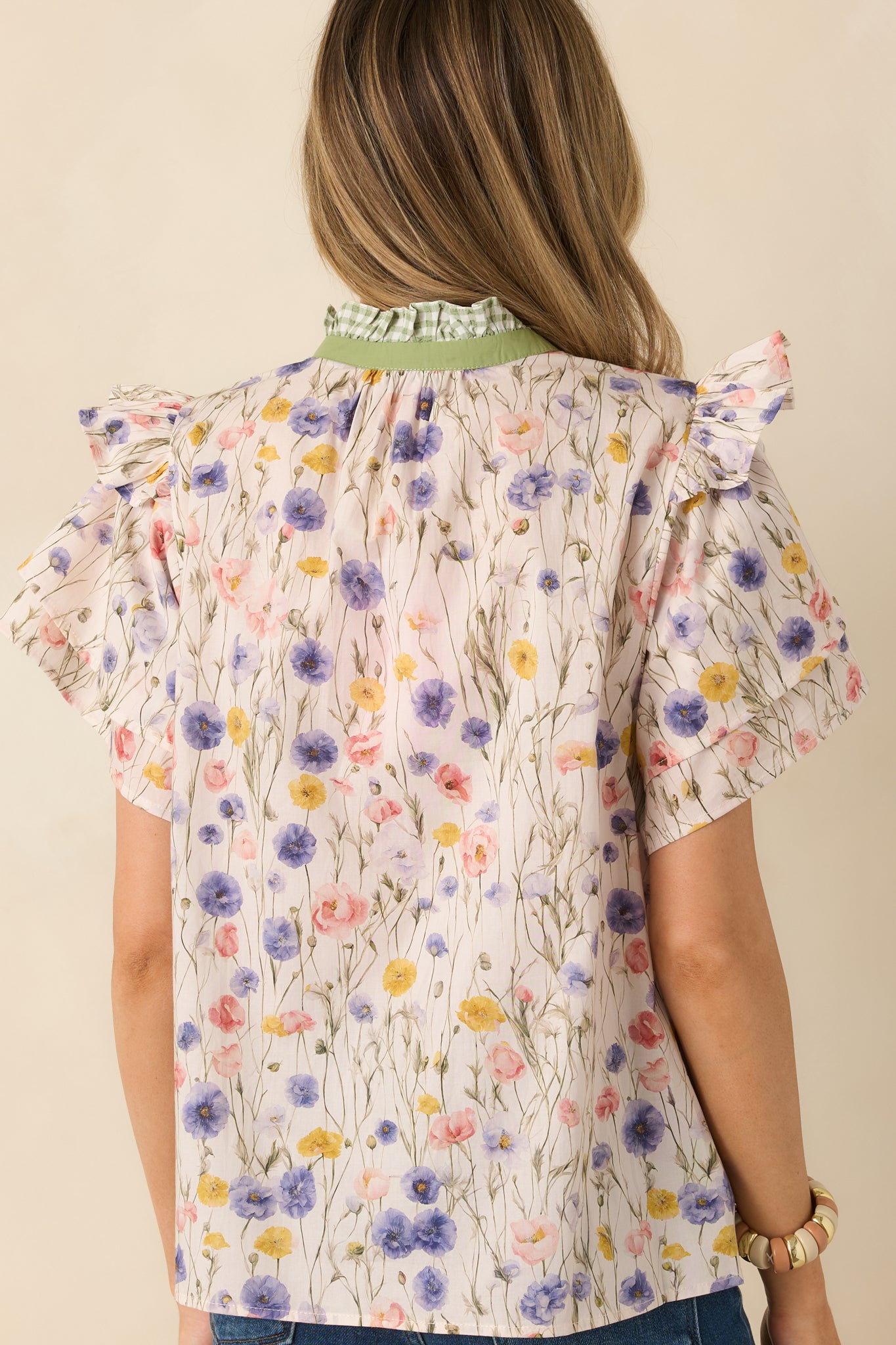 Ivory floral cotton blouse with the multicolor print continuing across the relaxed rear silhouette.