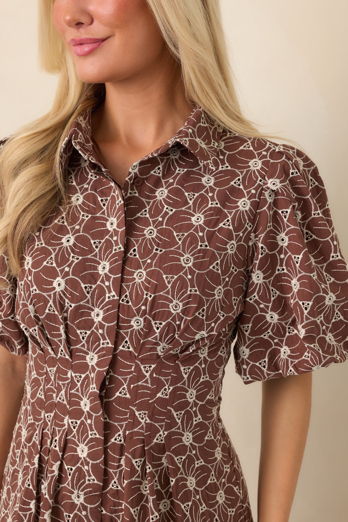 Close-up of the intricate ivory floral eyelet embroidery, highlighting the openwork pattern and delicate textured cotton construction.