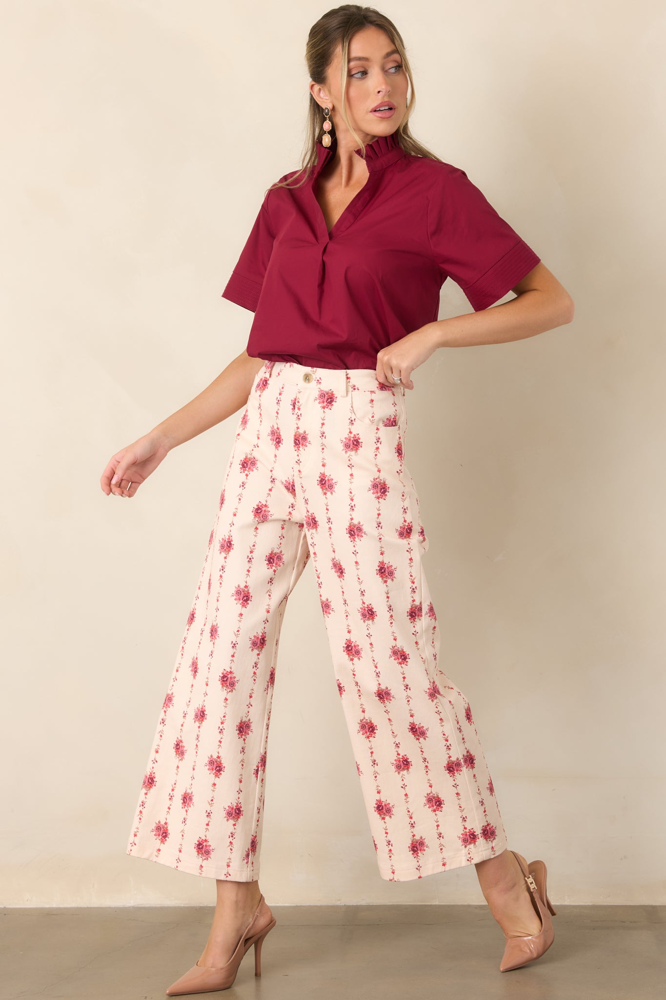 Ivory pants featuring delicate rose bouquets connected by trailing vines, a high-rise waist, and a straight silhouette.