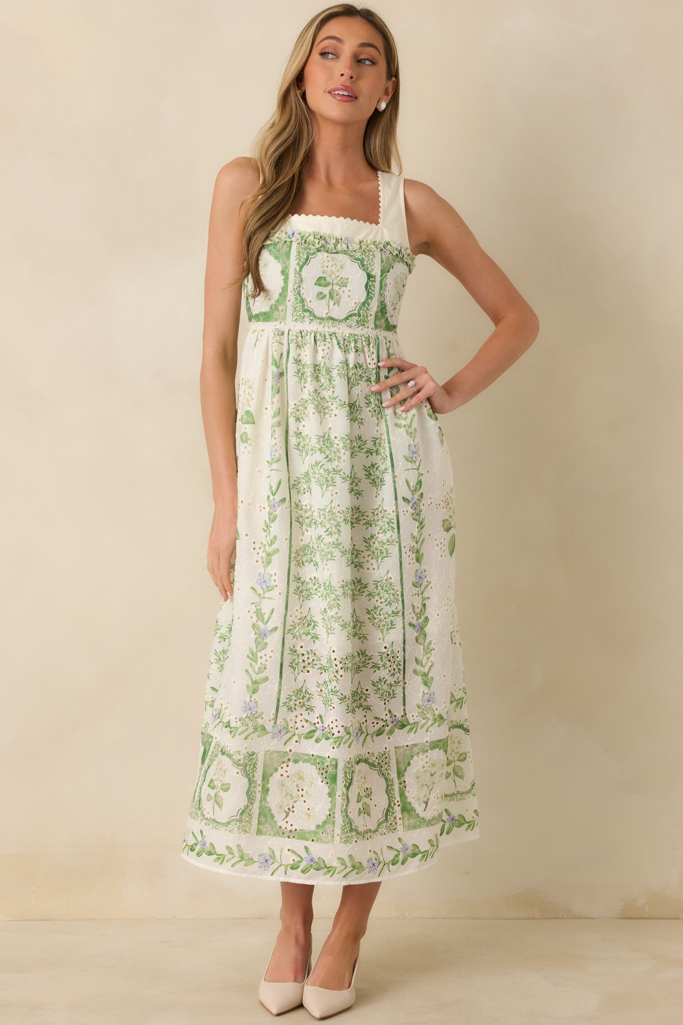 Ivory floral maxi dress emphasizing the balanced proportions of the fitted bodice and the airy, lined skirt with intricate floral paneling.