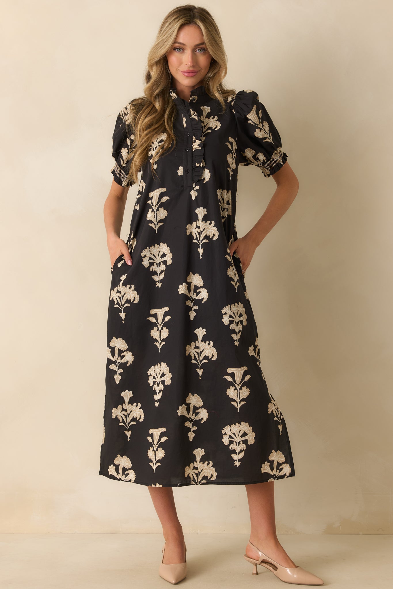 Ivory floral print maxi dress with smocked sleeve cuffs, side seam hem slits, and practical pockets.