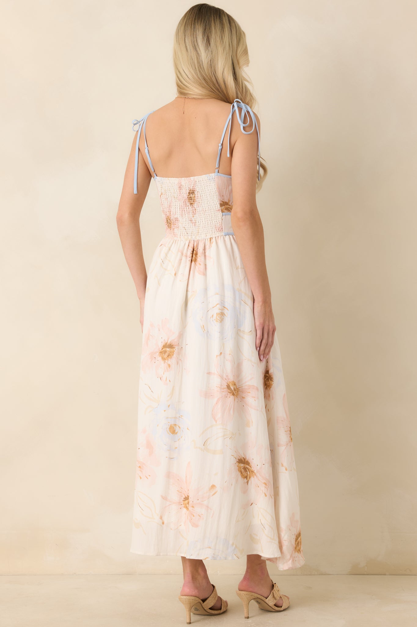 Back of the ivory floral midi dress featuring a comfortable smocked panel and adjustable tie straps.