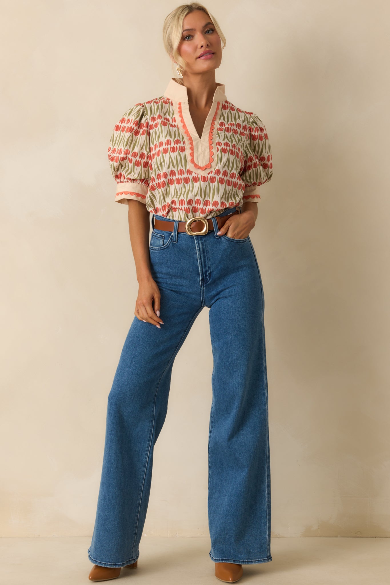 Ivory floral top showcasing embroidered scalloped trim along the sleeves and neckline for a soft, detailed look.