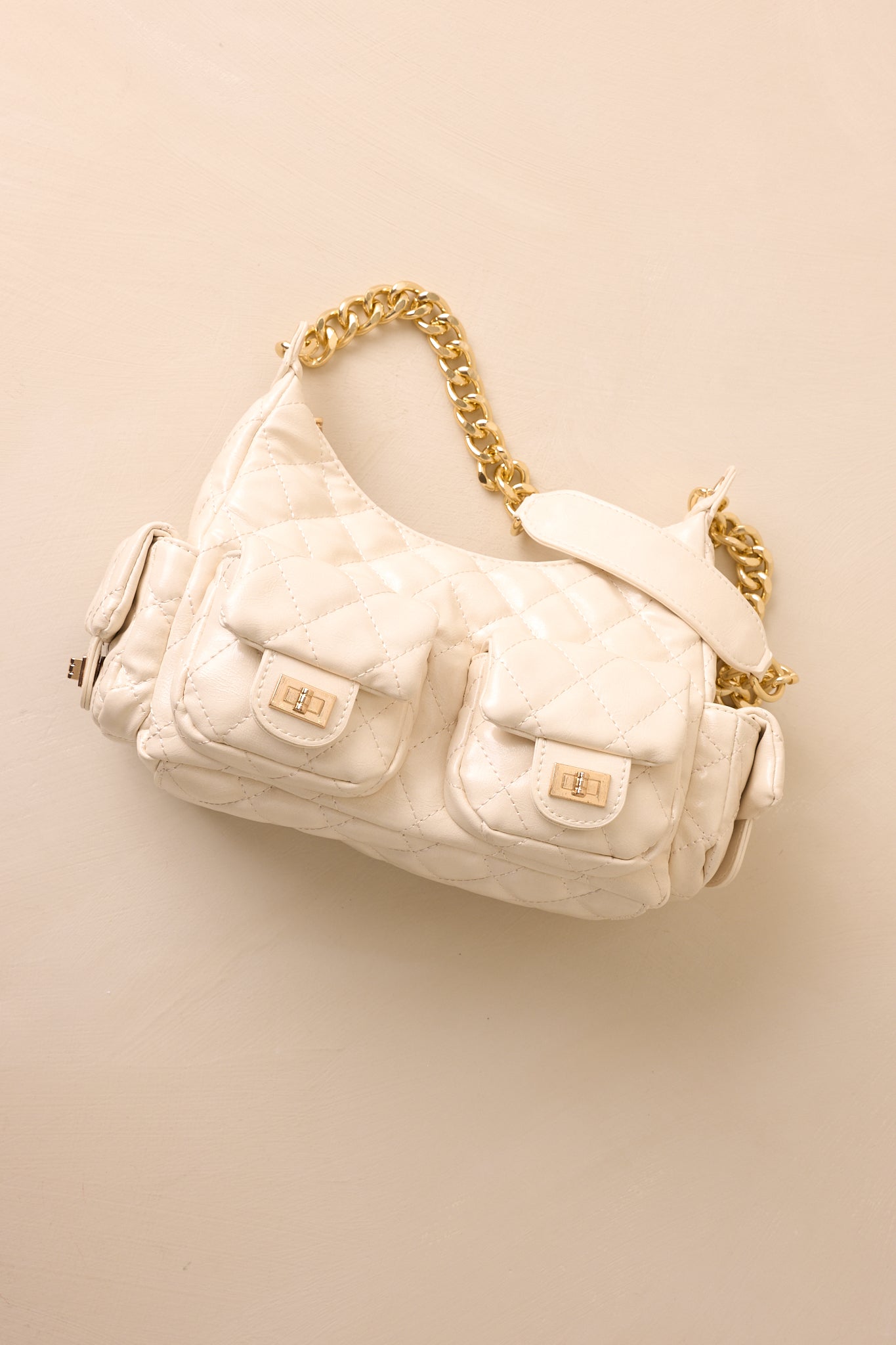 A cropped angled shot of the handbag focusing on the quilted faux leather texture and polished chain strap.