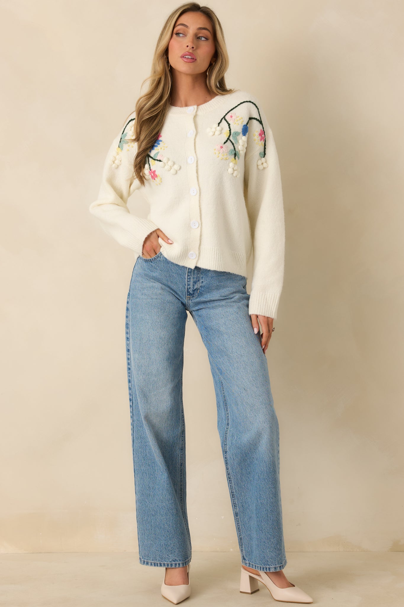 Ivory knit cardigan with a relaxed fit, round neckline, and long sleeves, finished with ribbed trim at the neckline, cuffs, and hem.
