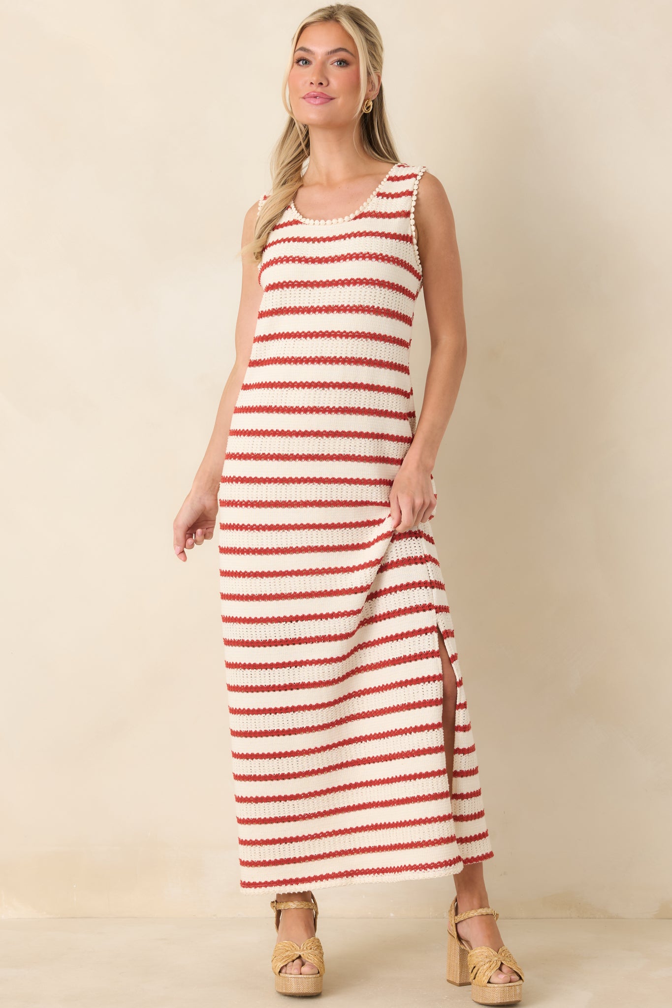 Timeless ivory knit dress with red horizontal stripes, sleeveless design, and relaxed fit with side slit detail.