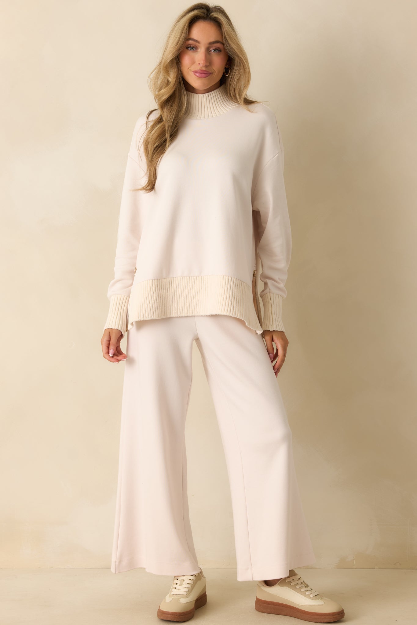 Wide-leg ivory knit pants with elastic waistband and casual, relaxed fit.