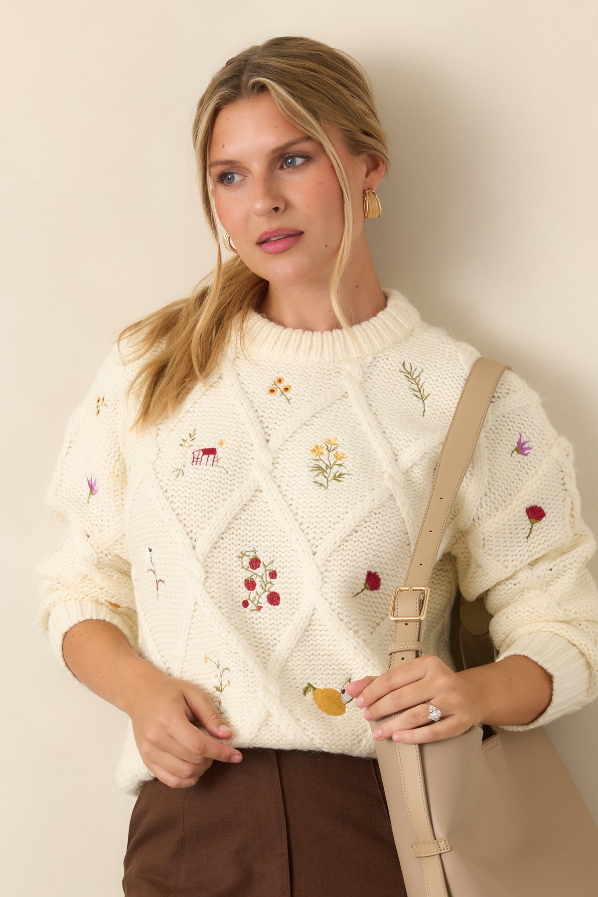 Ivory knit top showcasing the raised diamond pattern and colorful embroidered floral sprigs, berries, and fruit across the front.