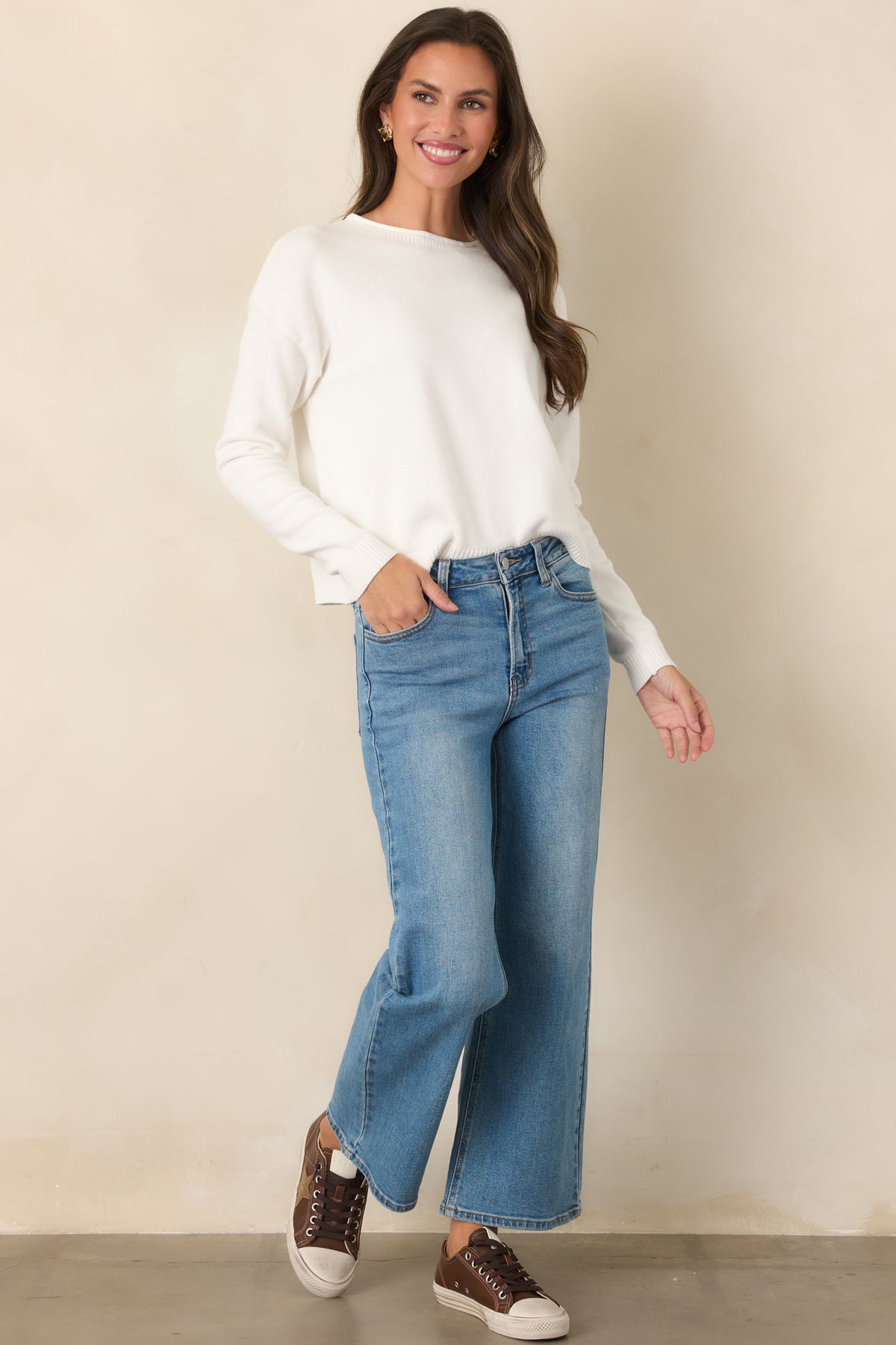 Clean ivory knit top featuring a shorter length, relaxed shape, and ribbed trim throughout.