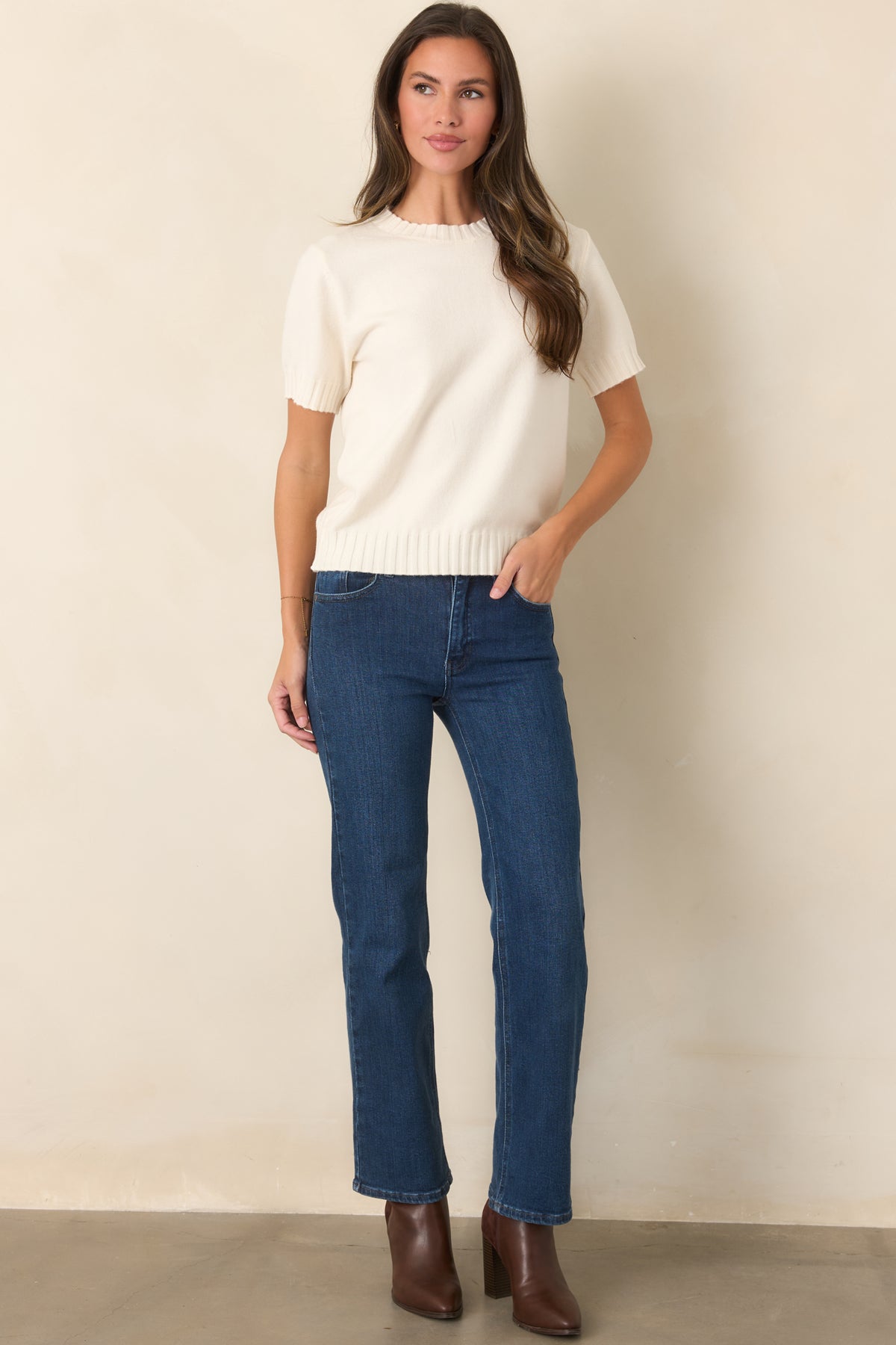 Ivory knit top with a polished relaxed silhouette, short sleeves, crew neckline, and subtle ribbed detailing throughout.