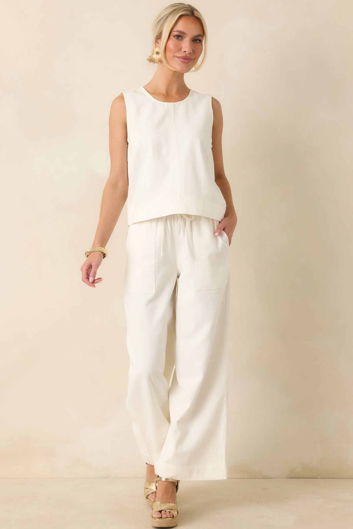 Ivory wide-leg pants in a lightweight drapey fabric featuring a relaxed silhouette and full-length flow.