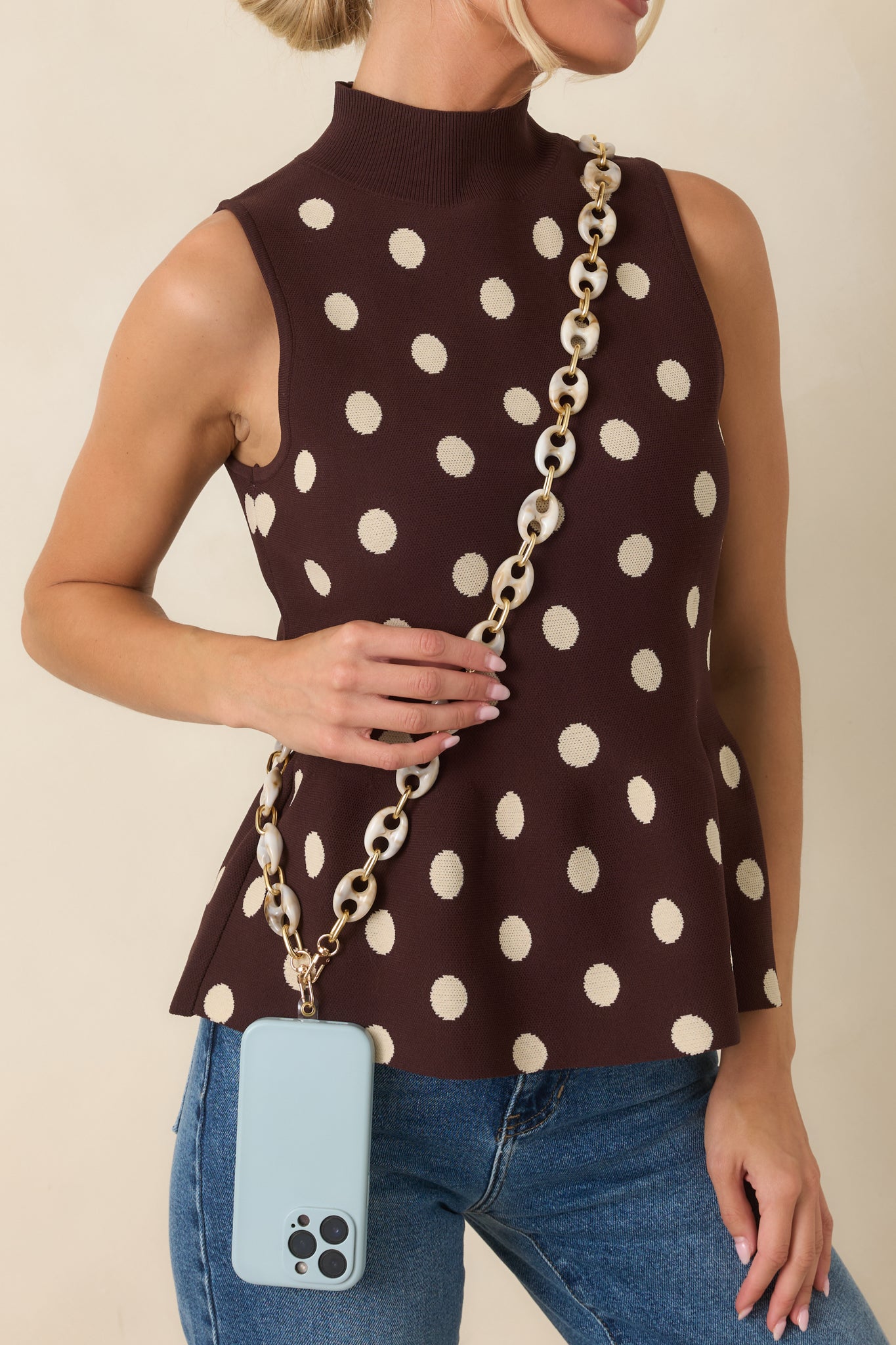 Ivory marbled resin link phone lanyard featuring oversized connected loops and polished gold-tone hardware for a statement accessory.