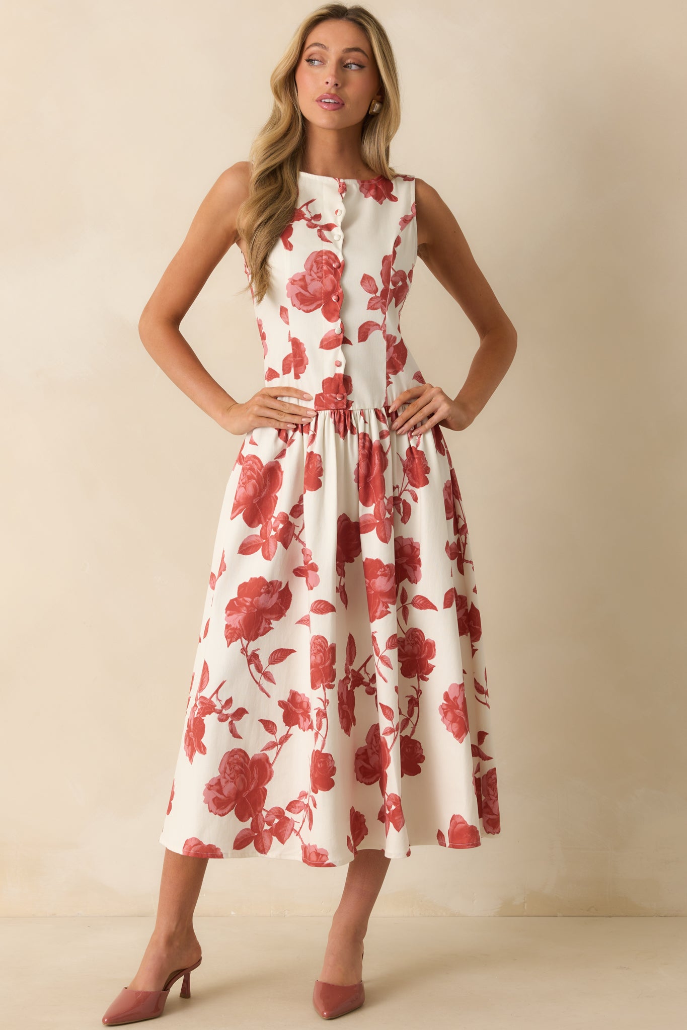Ivory maxi dress with brick red floral print and a sleeveless, round neckline design.
