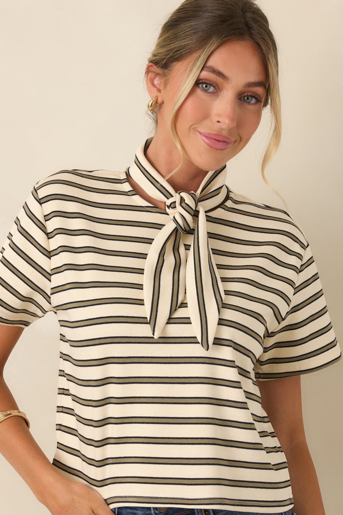 Cropped view of the ivory tee featuring slim olive stripes and a soft, flexible cotton-blend fabrication.