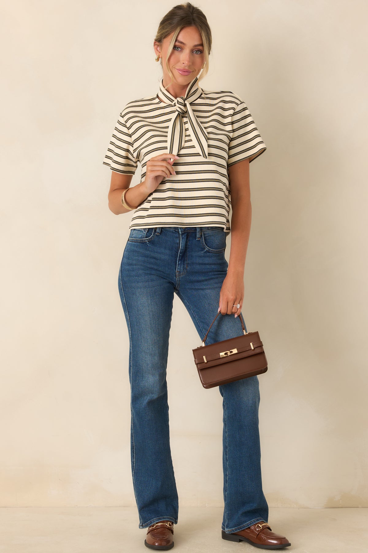 Ivory and olive striped tee featuring a relaxed short sleeve silhouette, soft cotton-blend construction, and evenly spaced horizontal stripes.