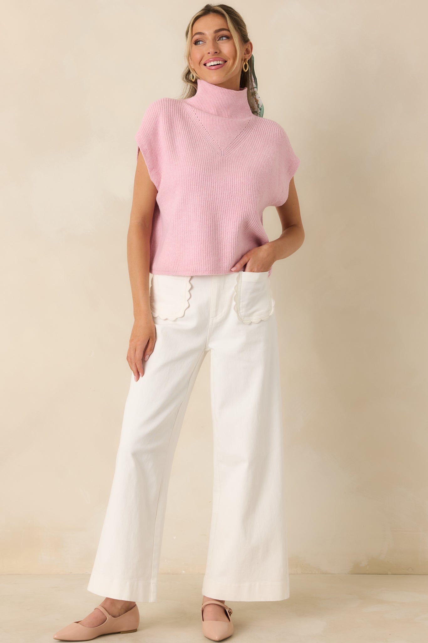 Front-facing view of ivory pants featuring high-rise waist, wide legs, and scalloped-trim patch pockets.