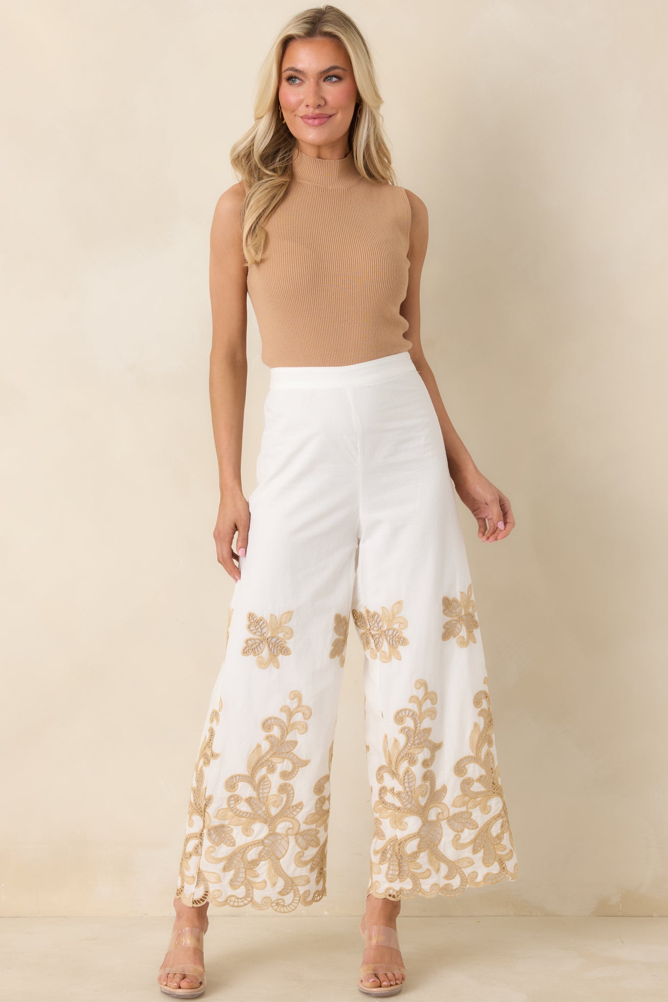 Ivory wide leg pants in breathable cotton with scalloped hem detail.