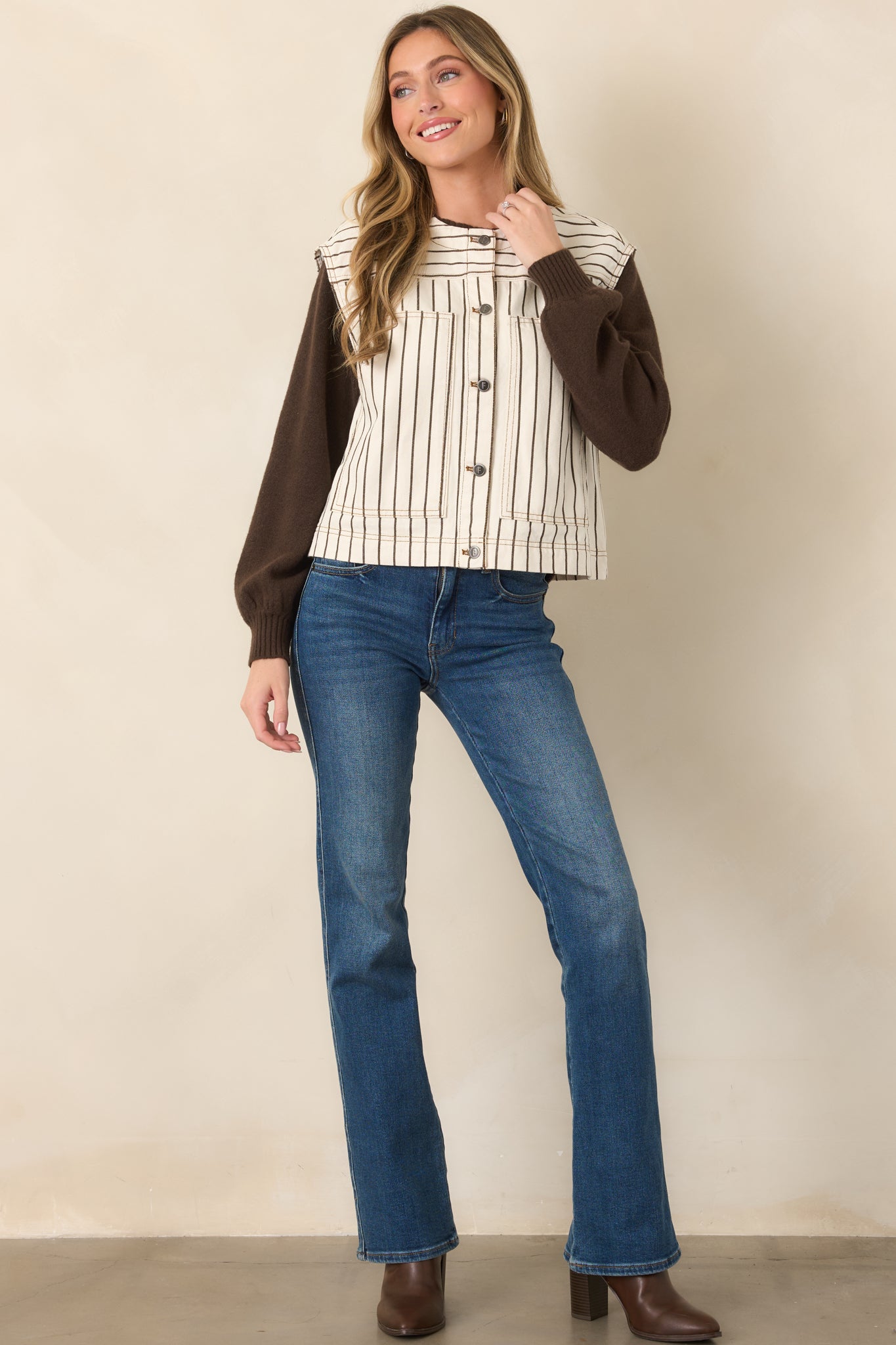 Ivory pinstripe vest showcasing its relaxed boxy shape, cap-style shoulders, oversized patch pockets, and distinctive striped yoke.