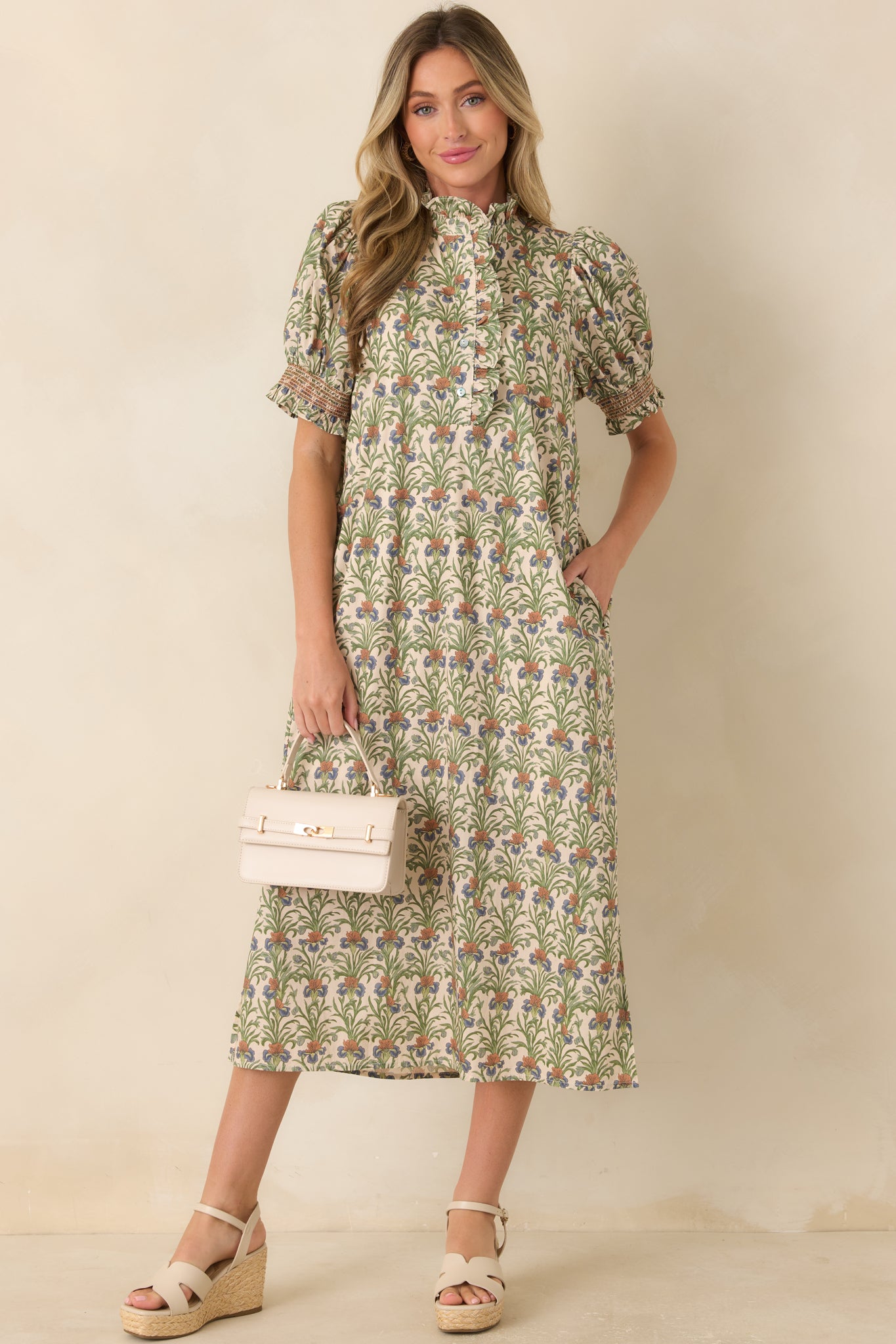 Ivory printed midi dress showcasing puff sleeves, a ruffle-trimmed neckline, and an easy A-line shape with soft movement.