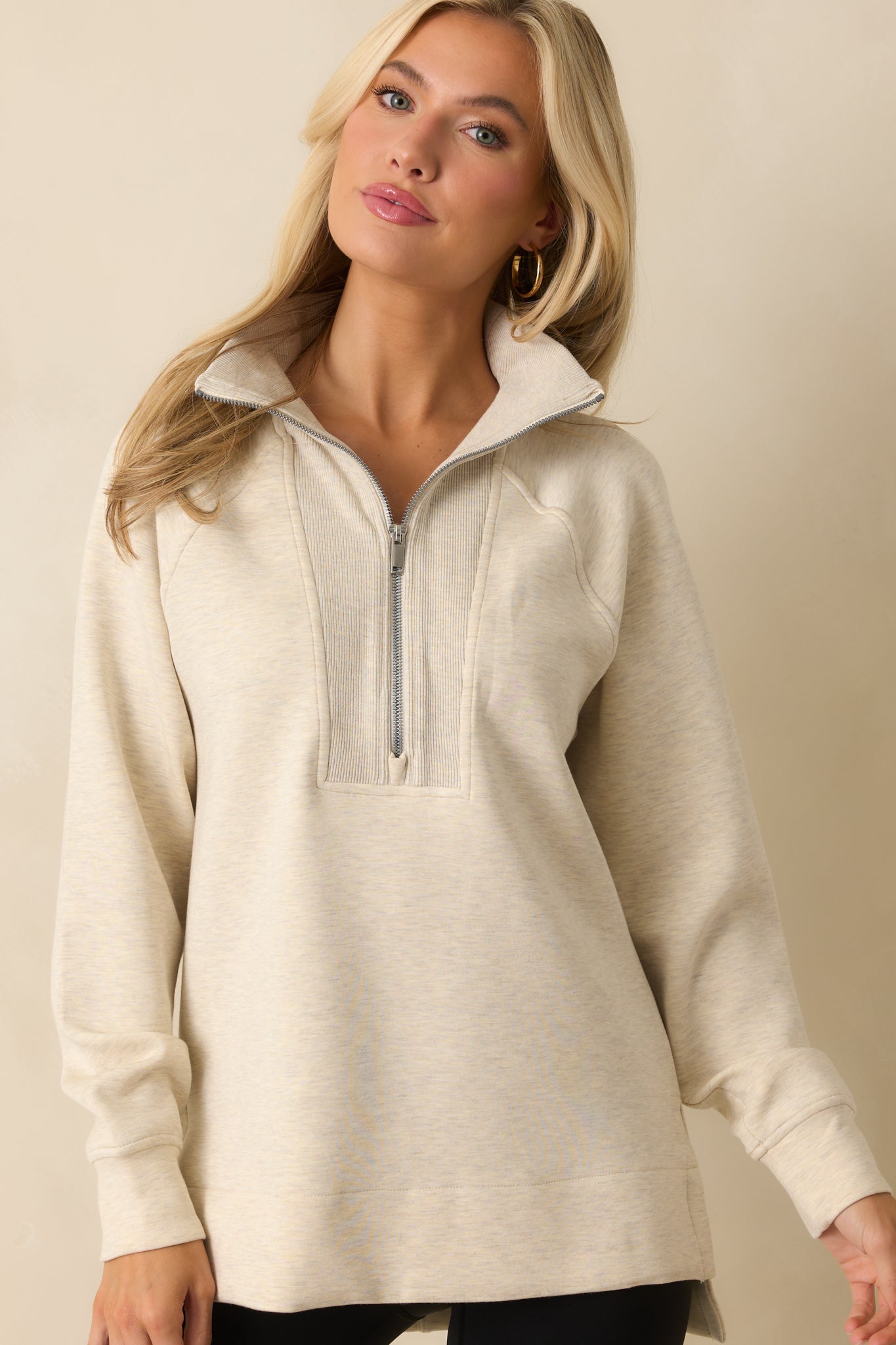 Ribbed cuffs and soft knit texture featured on the ivory long sleeve pullover.