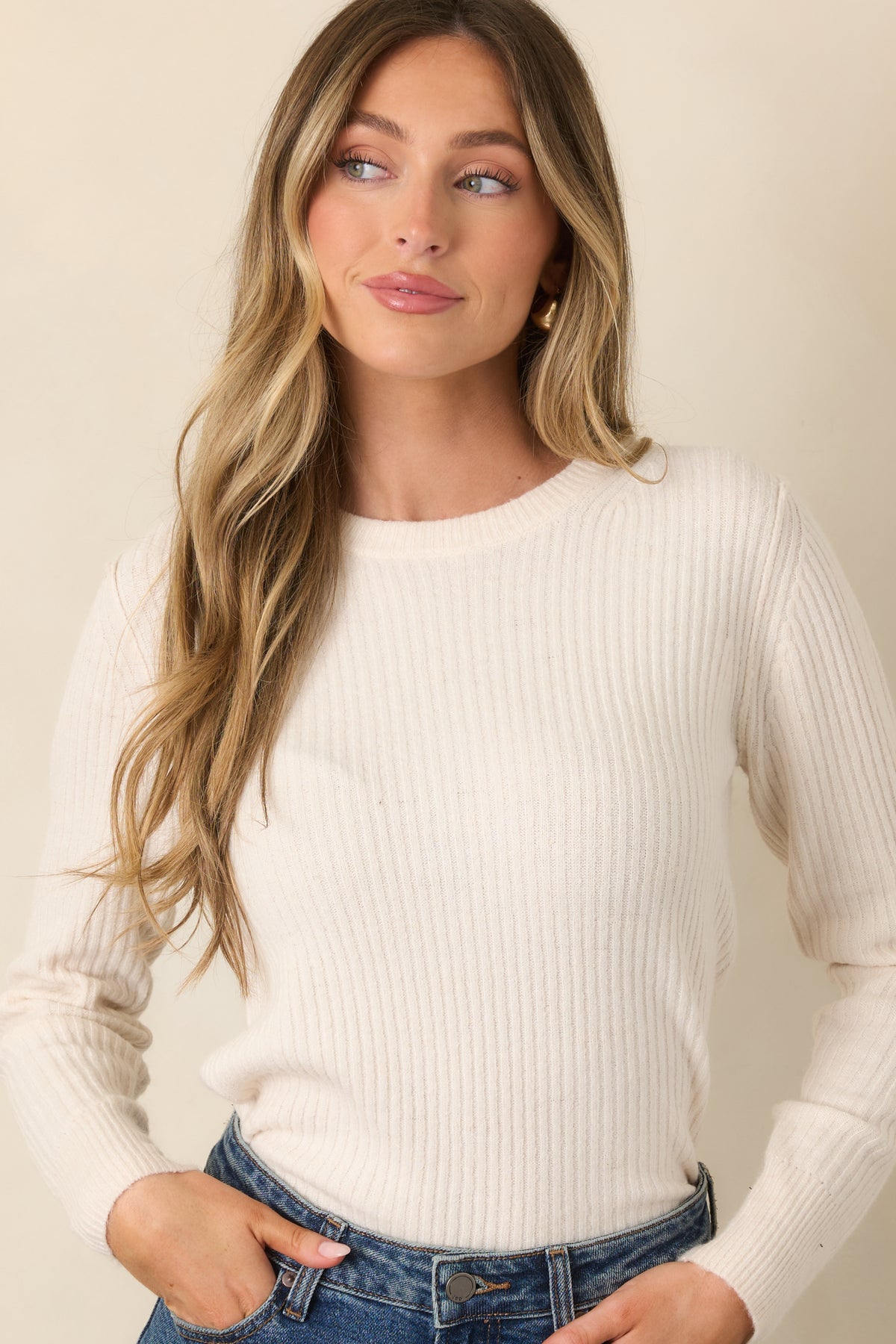 Ivory ribbed knit showcases the crew neckline and finely textured vertical construction.