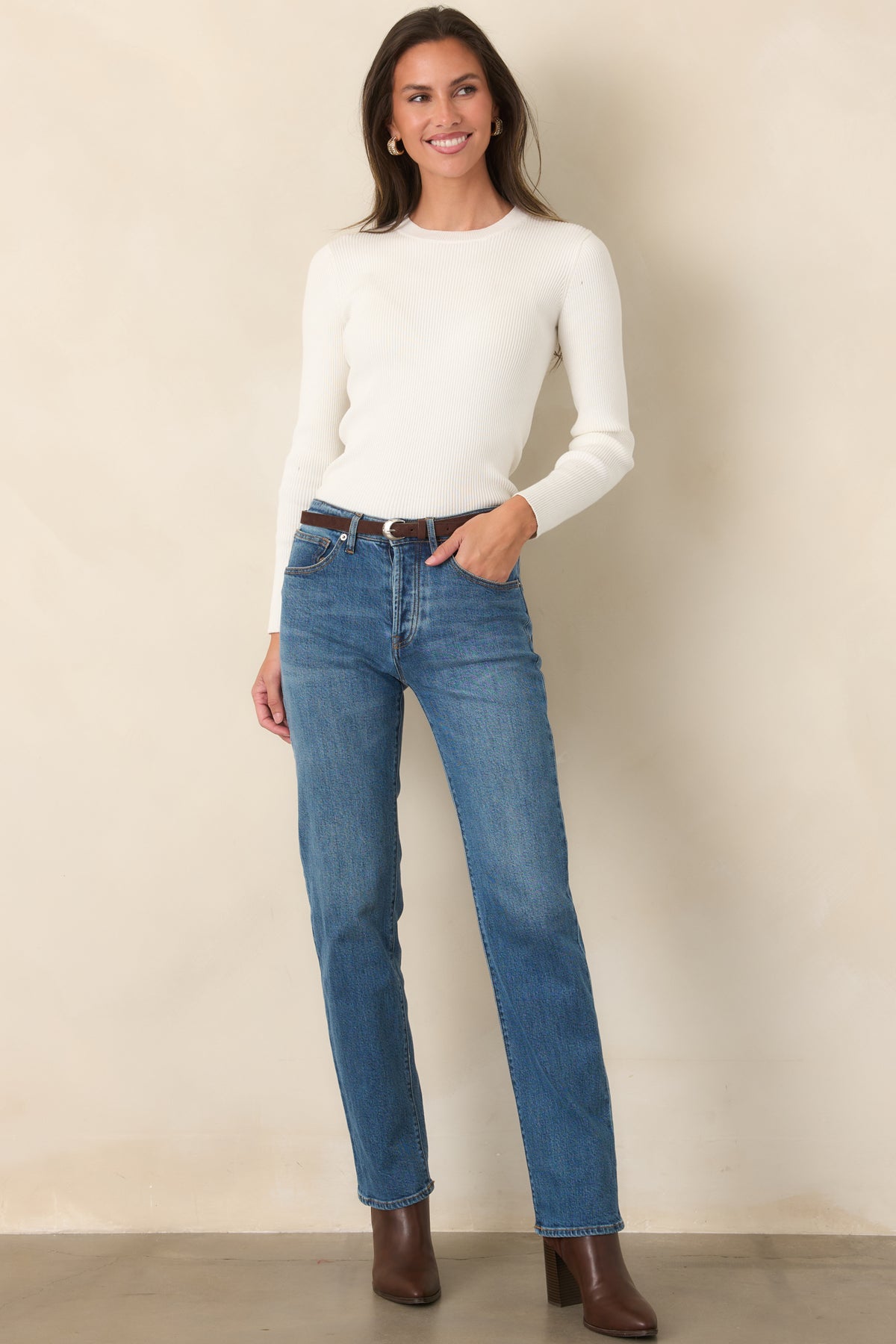 Ivory ribbed knit long sleeve top featuring a rounded neckline, narrow ribbed texture, and a slim, fitted shape.