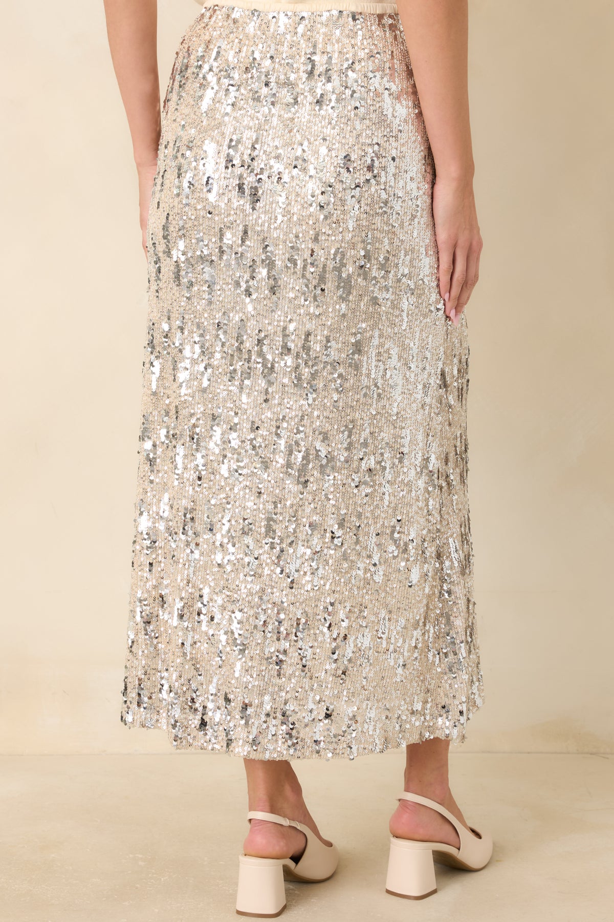 Rear of the ivory sequin midi skirt featuring an elastic waistband and shimmering silver embellishments.