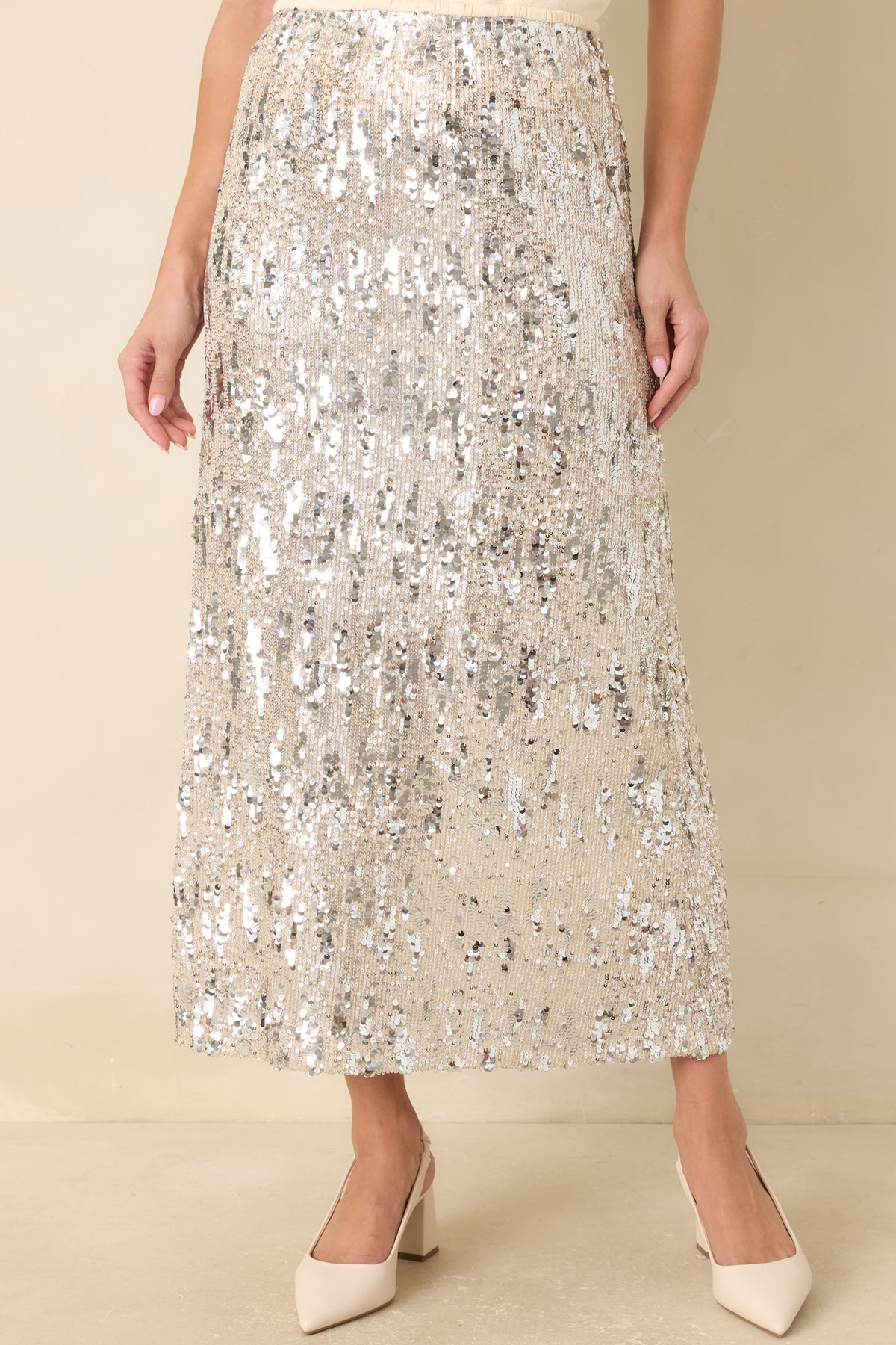 Elastic waistband on the ivory sequin skirt designed for a comfortable pull-on fit.