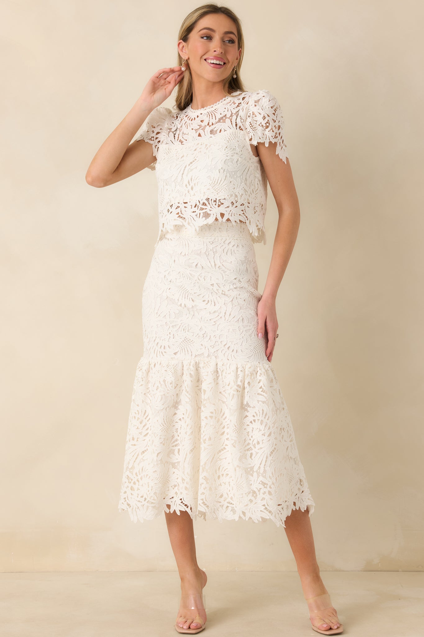 Full-length view of the ivory skirt emphasizing the drop-waist seam and softly flared midi silhouette.