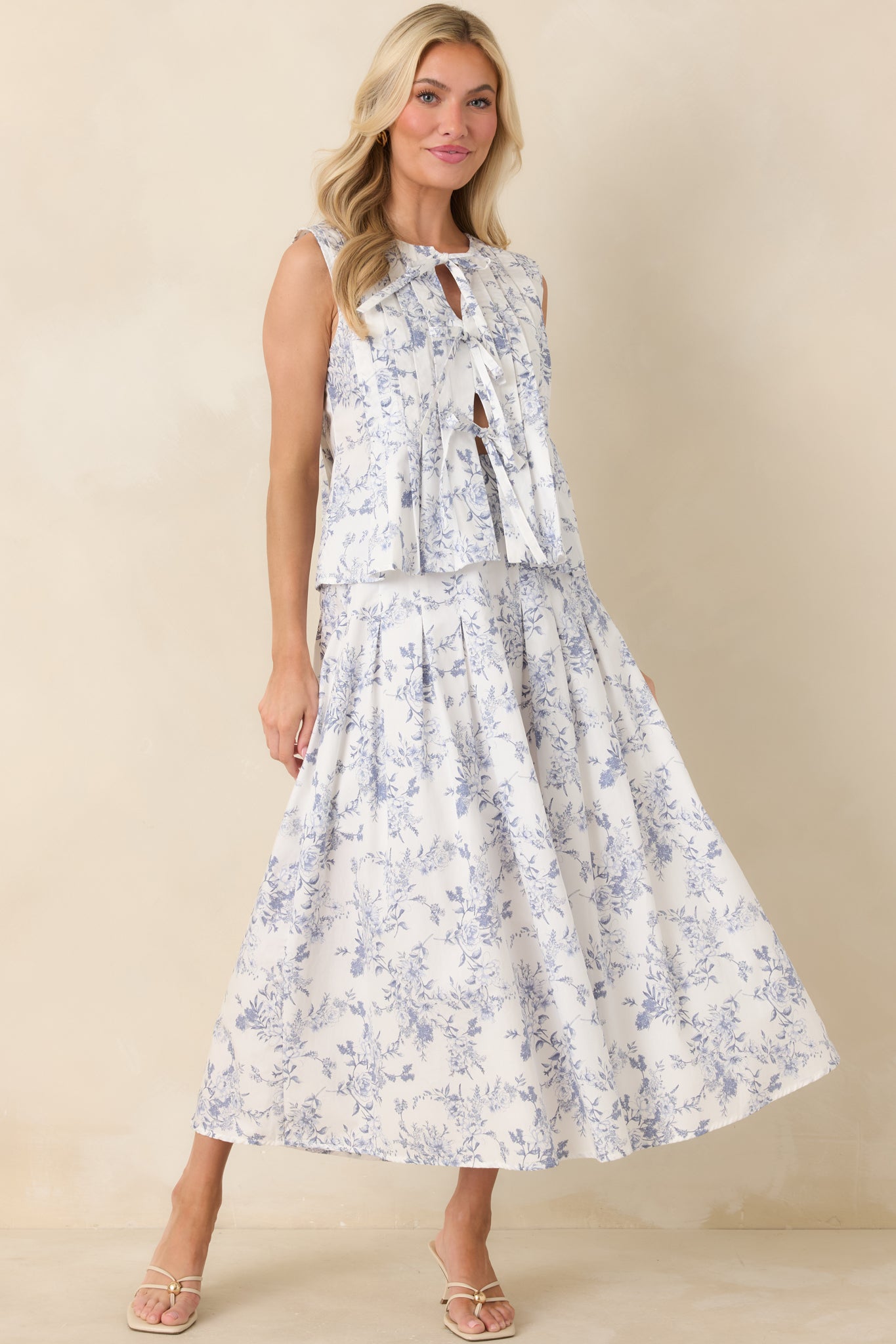 Ivory full-length skirt with a blue floral toile print, high-rise waistband, and gently gathered silhouette.