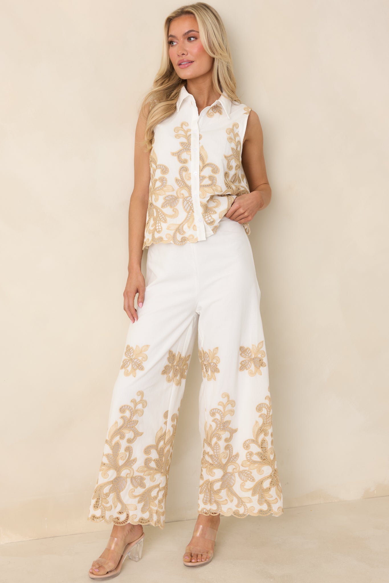 Ivory sleeveless cotton top with button-front design and delicate lace trim.