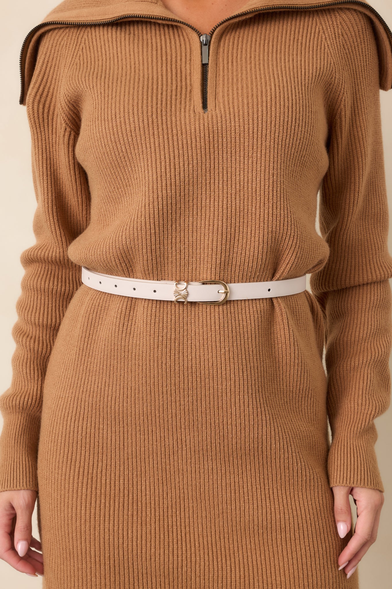 Ivory slim belt crafted from smooth faux leather with a streamlined silhouette and polished gold-tone buckle.