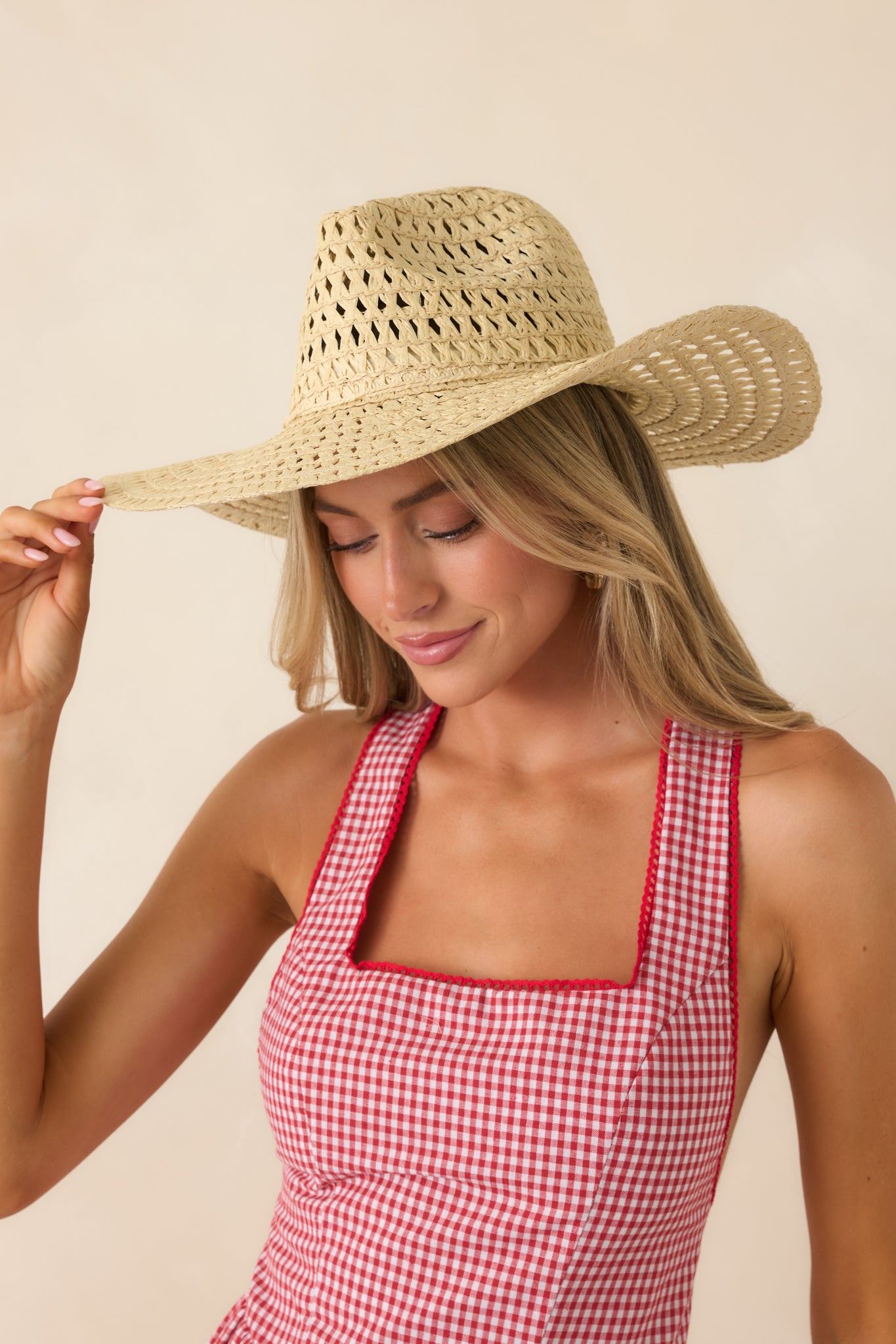 Polished ivory straw hat showcasing a classic Western shape, lightweight woven texture, and relaxed finish.
