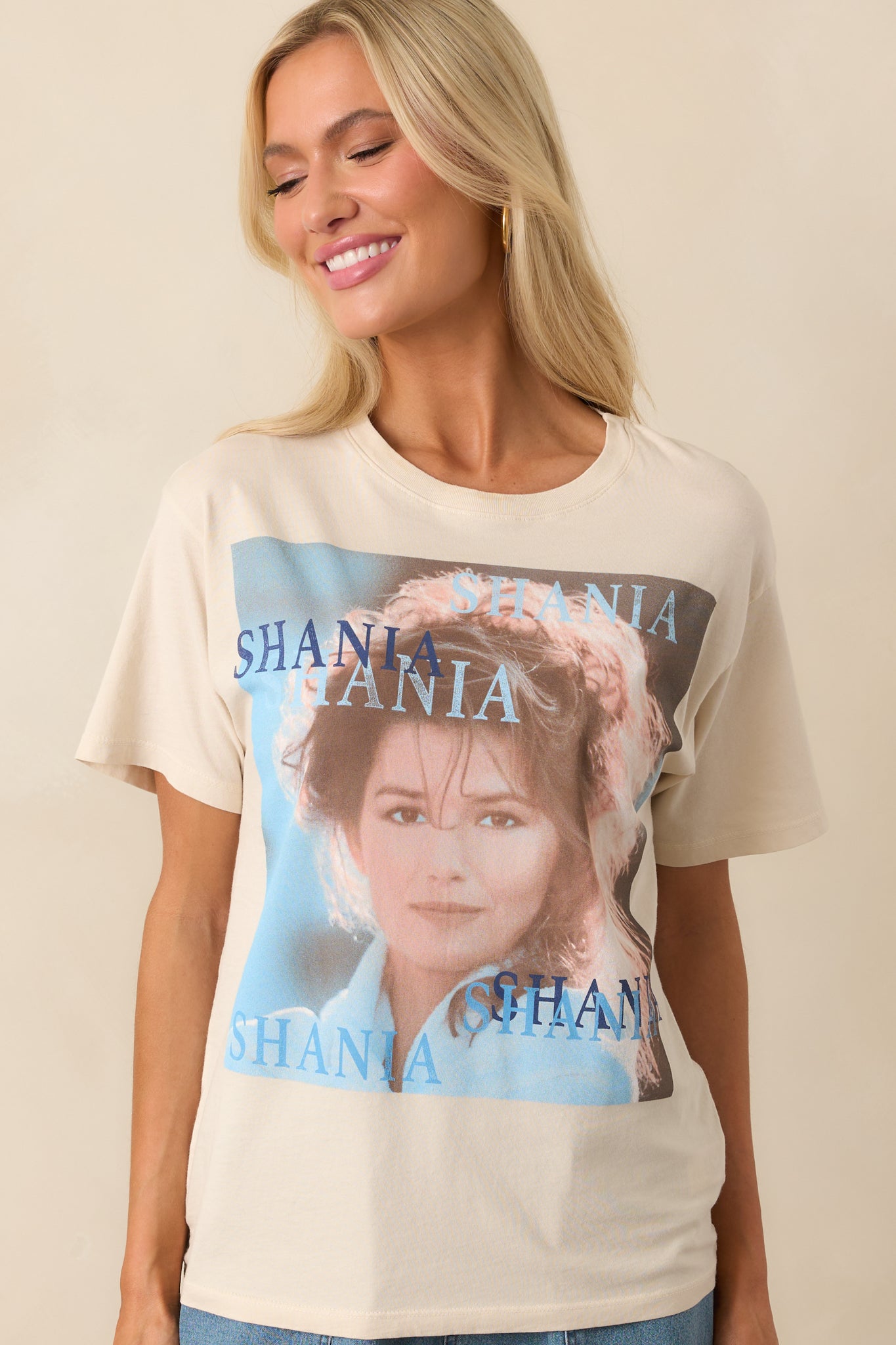 Front view of an ivory tee featuring the cover of a best-selling album, with a crew neckline, short sleeves, and a relaxed fit.