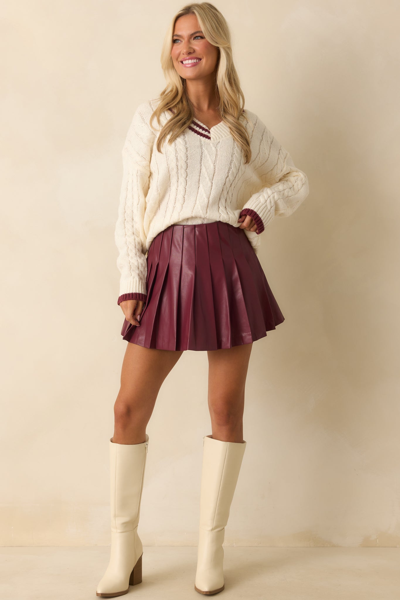 Ivory top highlighted by burgundy contrast trim and ribbed detailing at cuffs and hem.