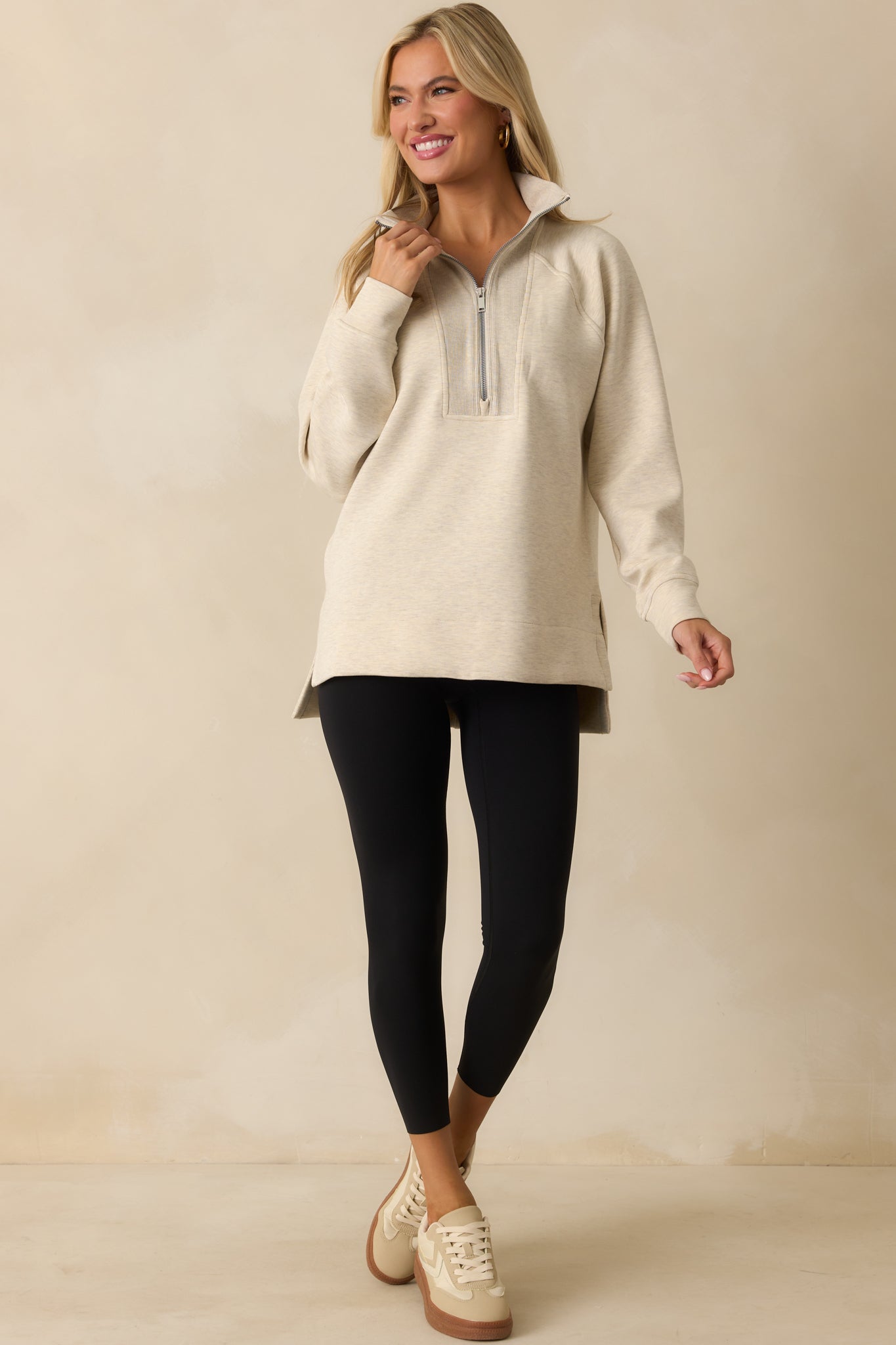 Ivory top with a high-low hem and side seam vent slits for easy movement.