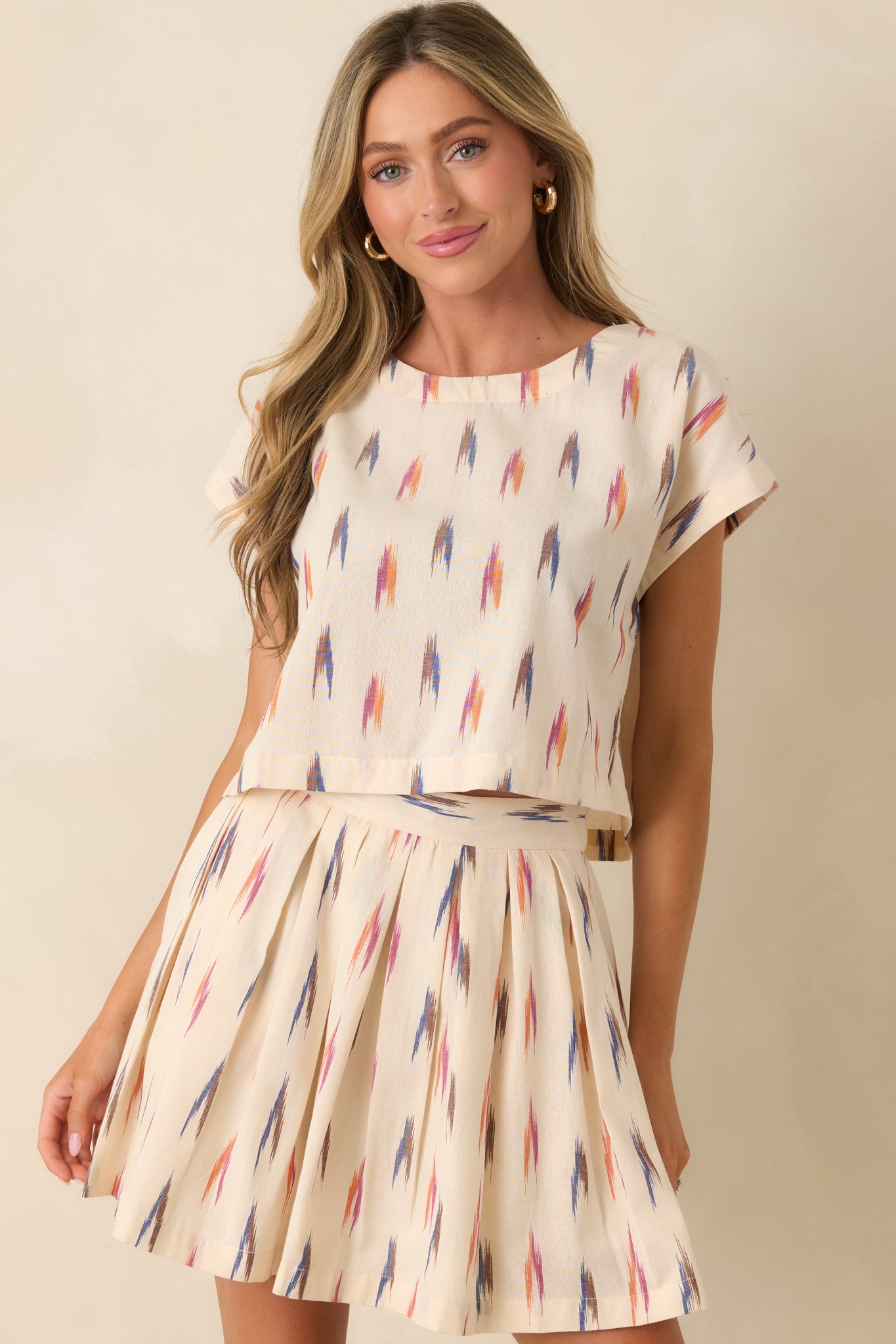 Ivory top highlighting the abstract graphic design and dolman cap sleeves.