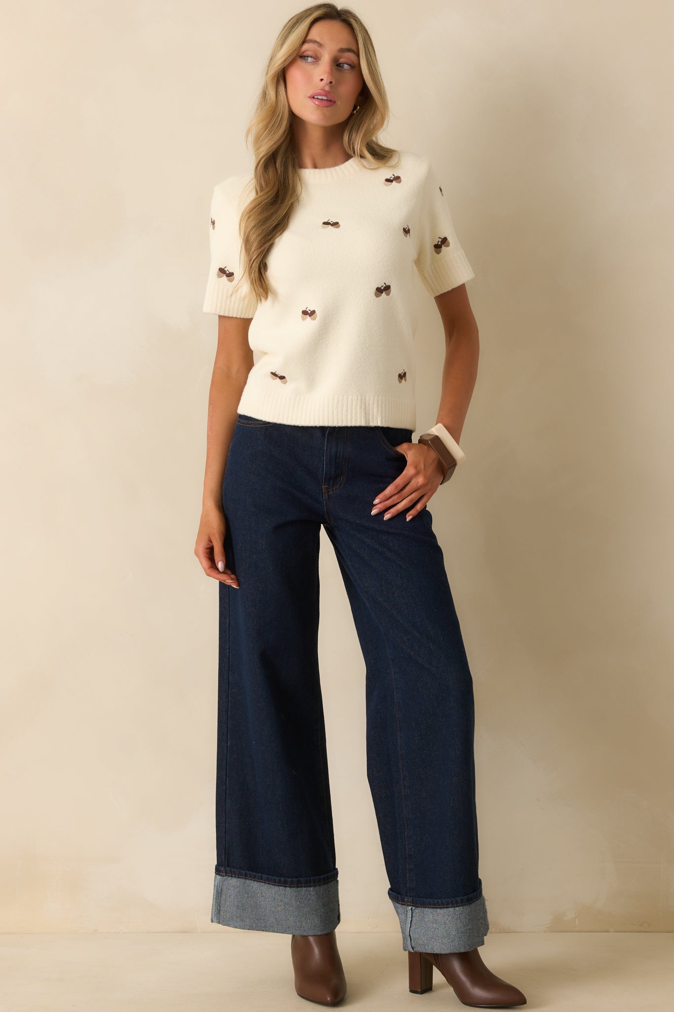 Ivory top with subtle texture, ribbed detailing, and embroidered accents.