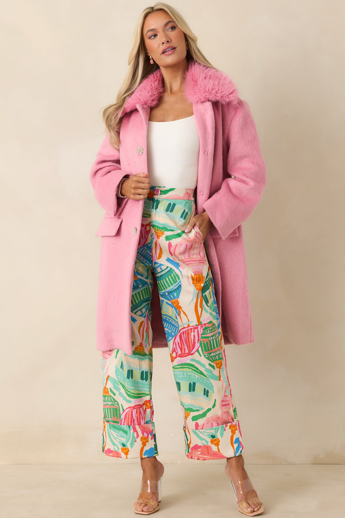 Ivory wide-leg pants featuring a colorful oversized ornament print in pink, coral, orange, blue, and green.