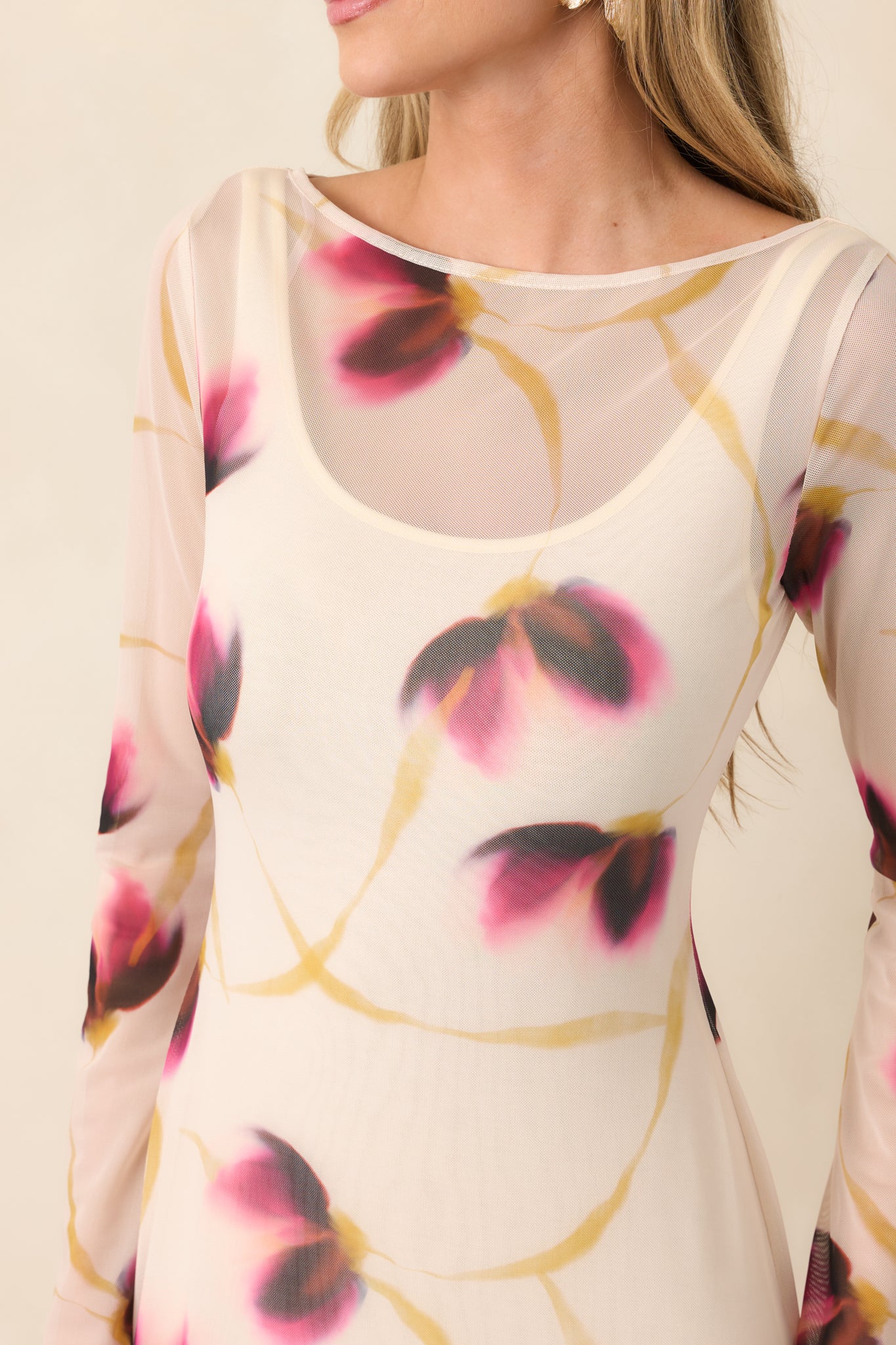 Close-up of the ivory mesh fabric featuring blurred wine, pink, and golden floral accents with delicate sheer texture.