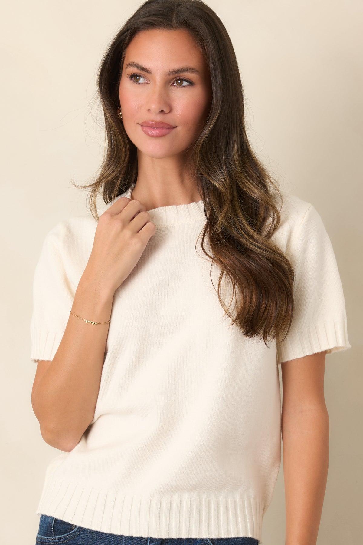Ivory wool-blend knit top highlighting the classic crew neckline, short sleeves, and ribbed neckline trim.