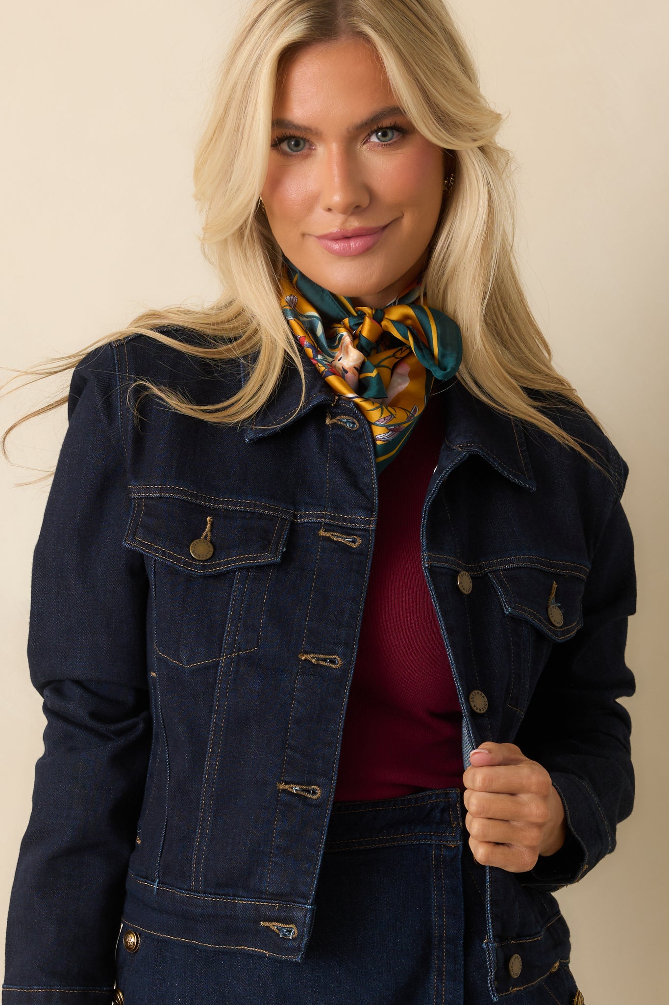 Jacket showing chest pocket buttons and detailed topstitching along the seams.