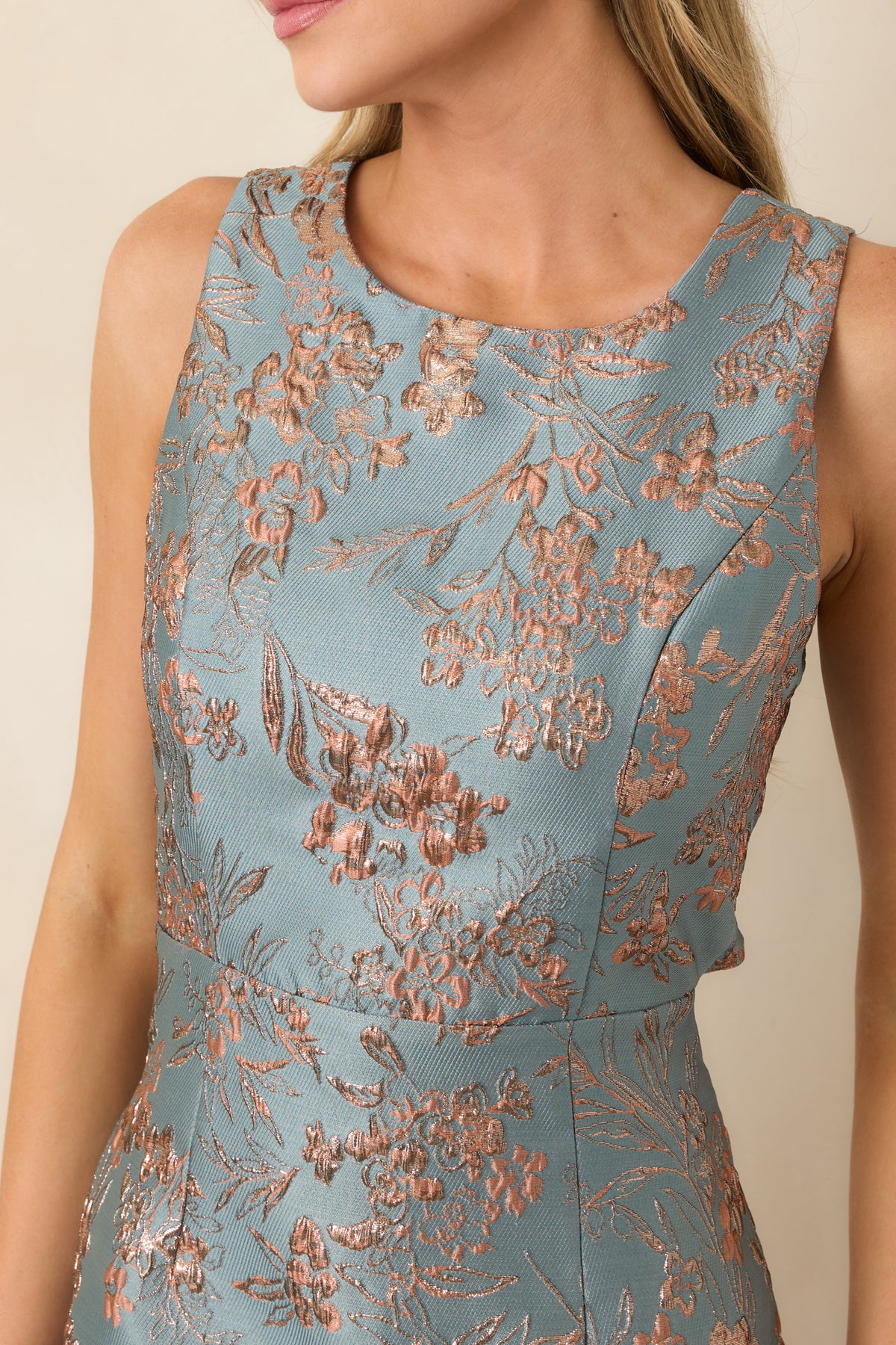 Close-up of the jacquard dress showing shimmering rose-gold floral motifs and textured fabric.