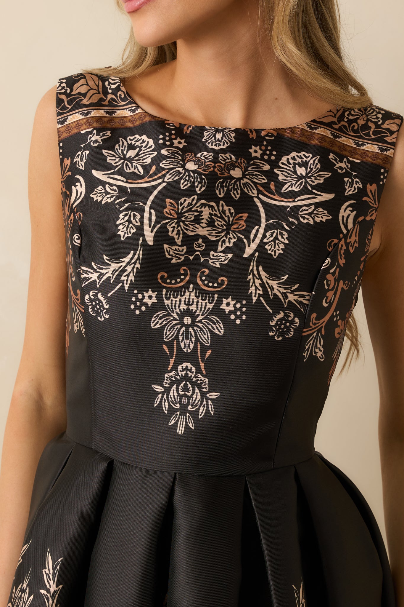 Close-up of the jacquard fabric, pleated skirt texture, and bateau neckline detailing.