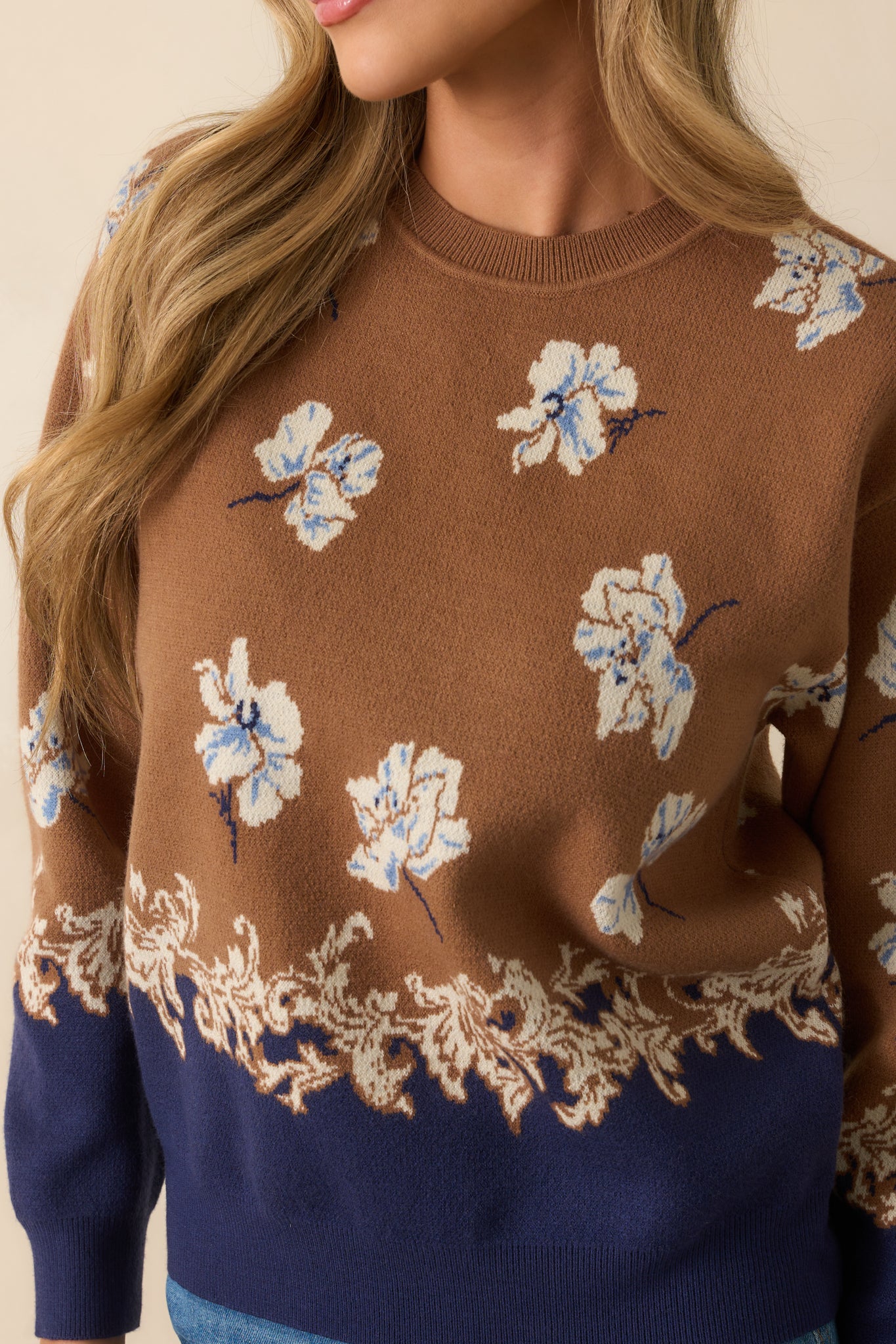 Up-close shot of the jacquard knit showing intricate blue floral design.
