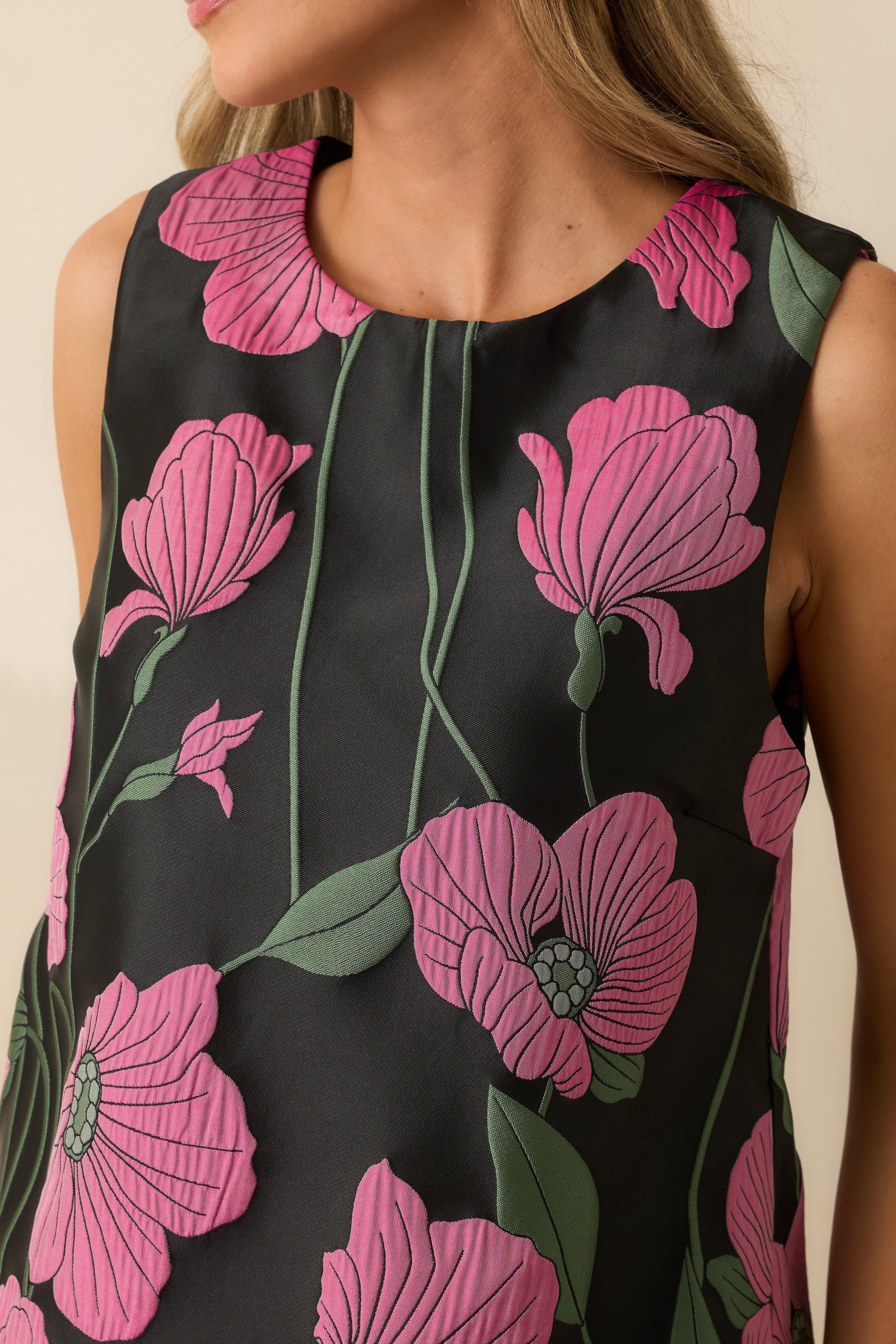 Detailed look at the jacquard weave showing the pink and green floral pattern and textured finish.