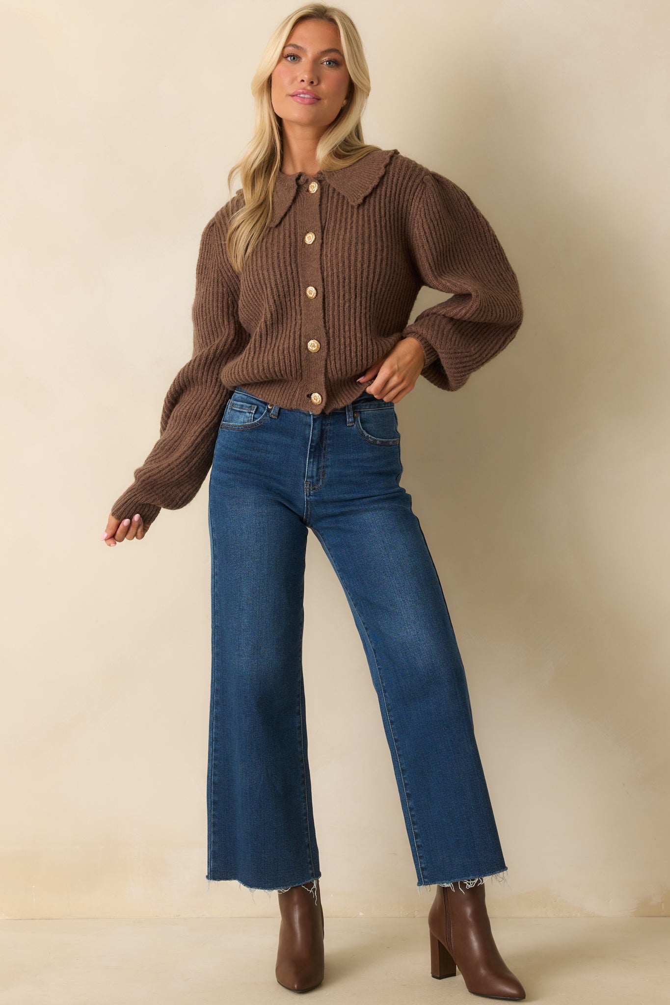 A full body front angle highlighting the raw hem and relaxed silhouette of the jeans.