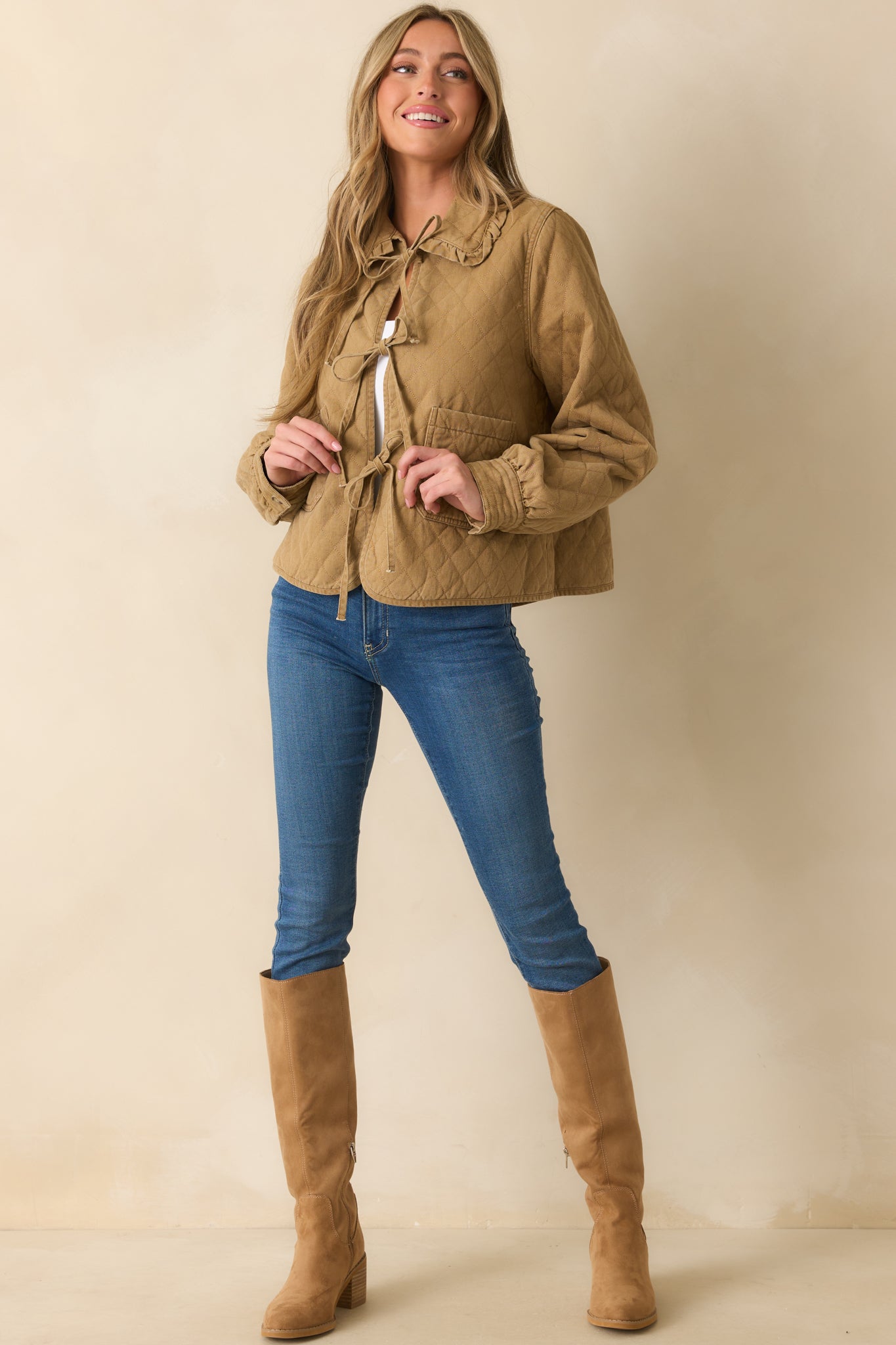 Khaki brown quilted jacket with oversized ruffle-trim Peter Pan collar and long sleeves with button cuffs.