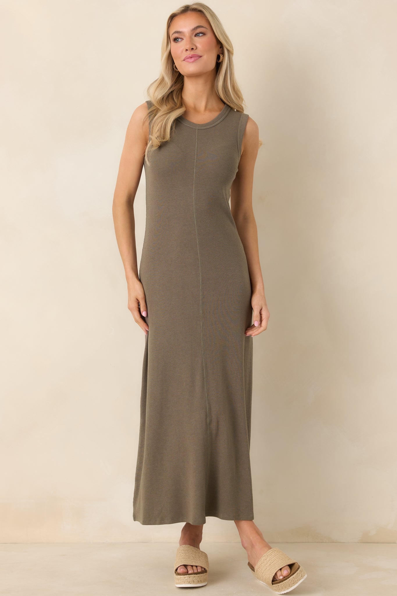 Soft khaki green maxi dress with a fitted top and airy full-length skirt for a flattering silhouette.