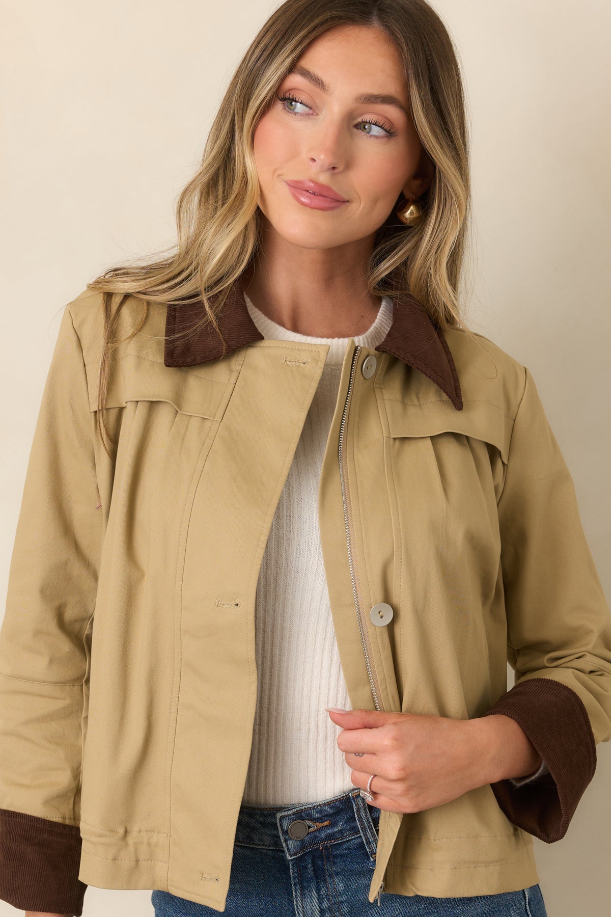 Khaki jacket with a relaxed fit, brown corduroy collar, front pleating, and concealed zipper closure.